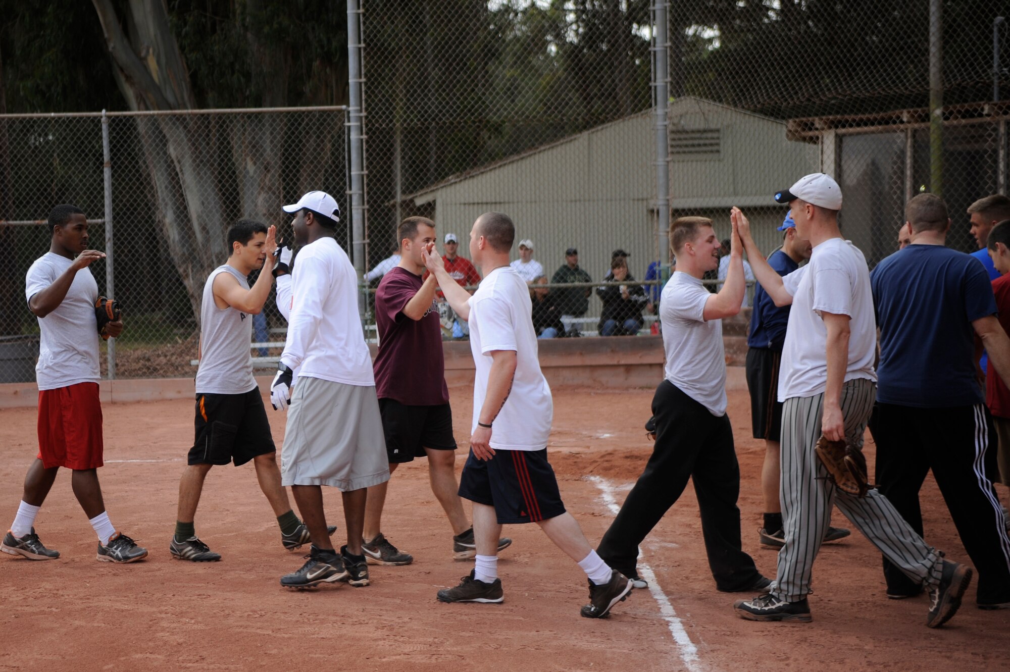 VANDENBERG AIR FORCE BASE, Calif. -- The 30th Security Forces Squadron team congratulates the 381st Training Group team after an intramural softball league game here Tuesday, June 28, 2011.  The 381st TRG won the game 21-9.  (U.S. Air Force photo/Staff Sgt. Andrew Satran) 
