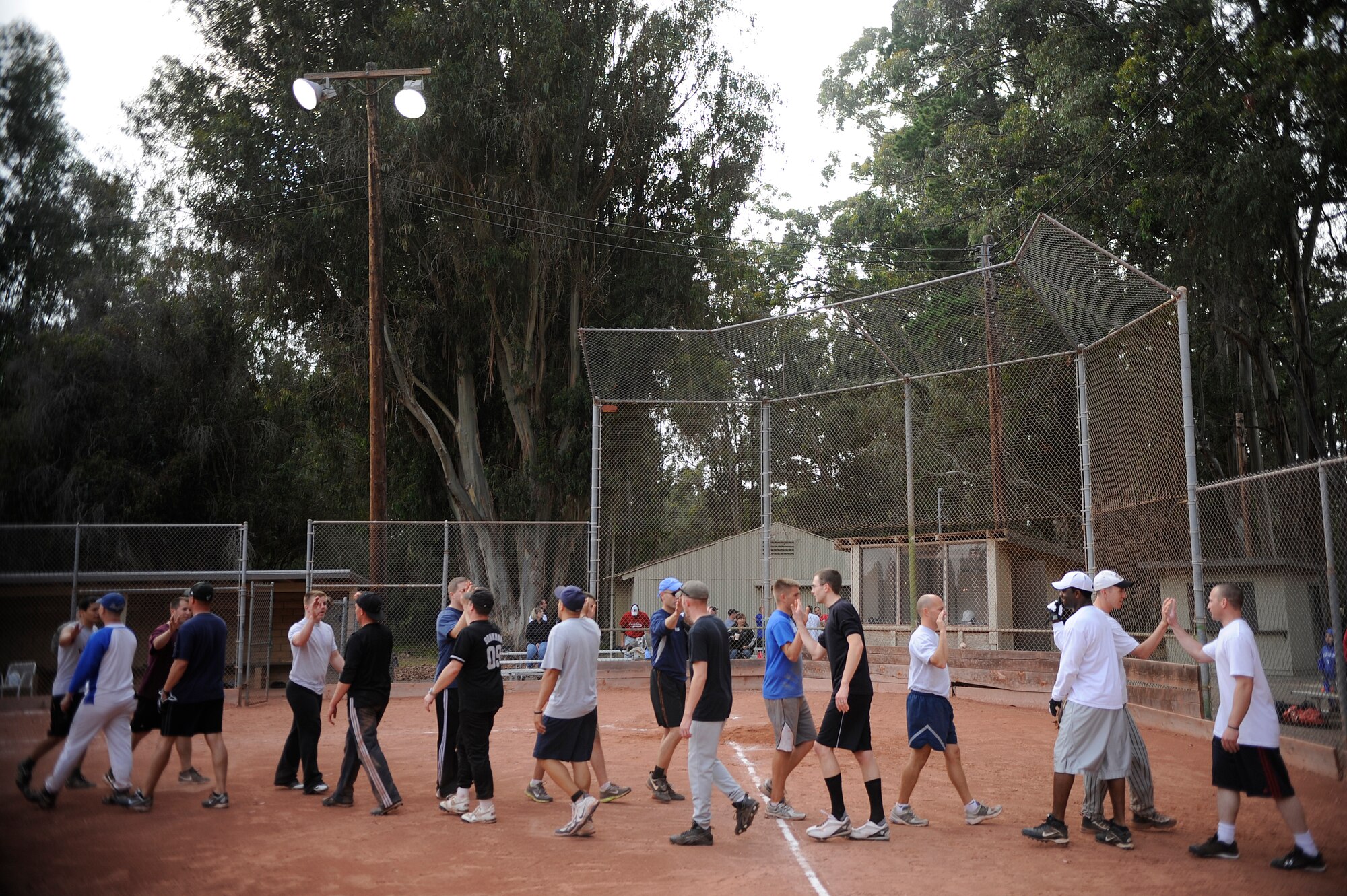 VANDENBERG AIR FORCE BASE, Calif. -- The 30th Security Forces Squadron team congratulates the 381st Training Group team after an intramural softball league game here Tuesday, June 28, 2011.  The 381st TRG won the game 21-9.  (U.S. Air Force photo/Staff Sgt. Andrew Satran) 
