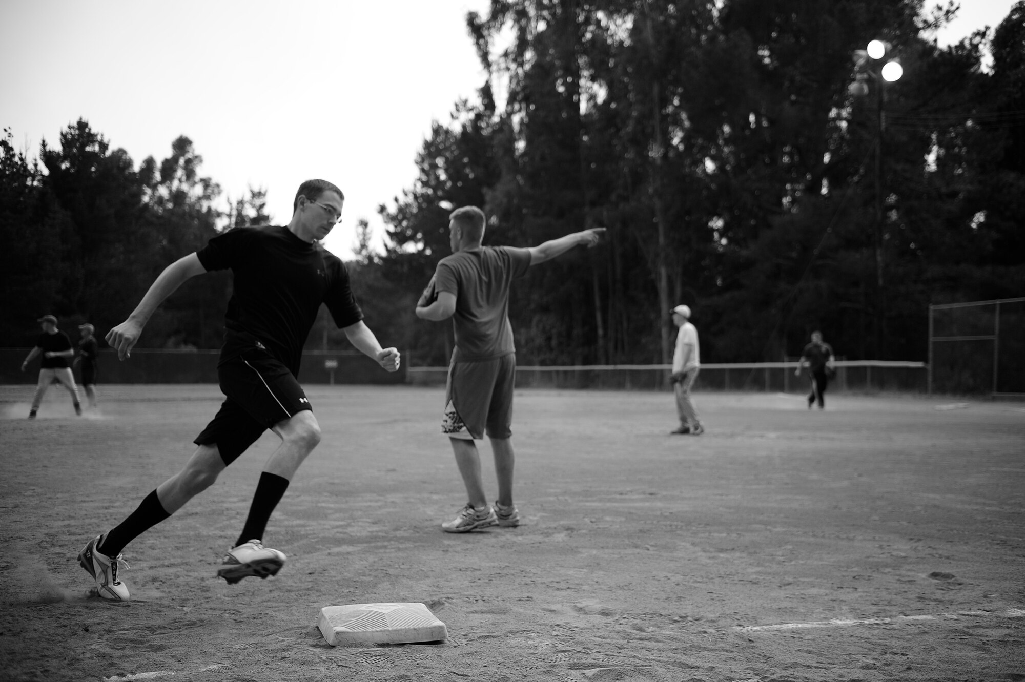 VANDENBERG AIR FORCE BASE, Calif. -- Sprinting to third base, Brandon Mitcheltree, a 30th Security Forces Squadron team member, heads toward homeplate during a softball game at the baseball field here Tuesday, June 28, 2011.  The 30th SFS team lost the game against the 381st Training Group team 21-9.  (U.S. Air Force photo/Staff Sgt. Andrew Satran) 
