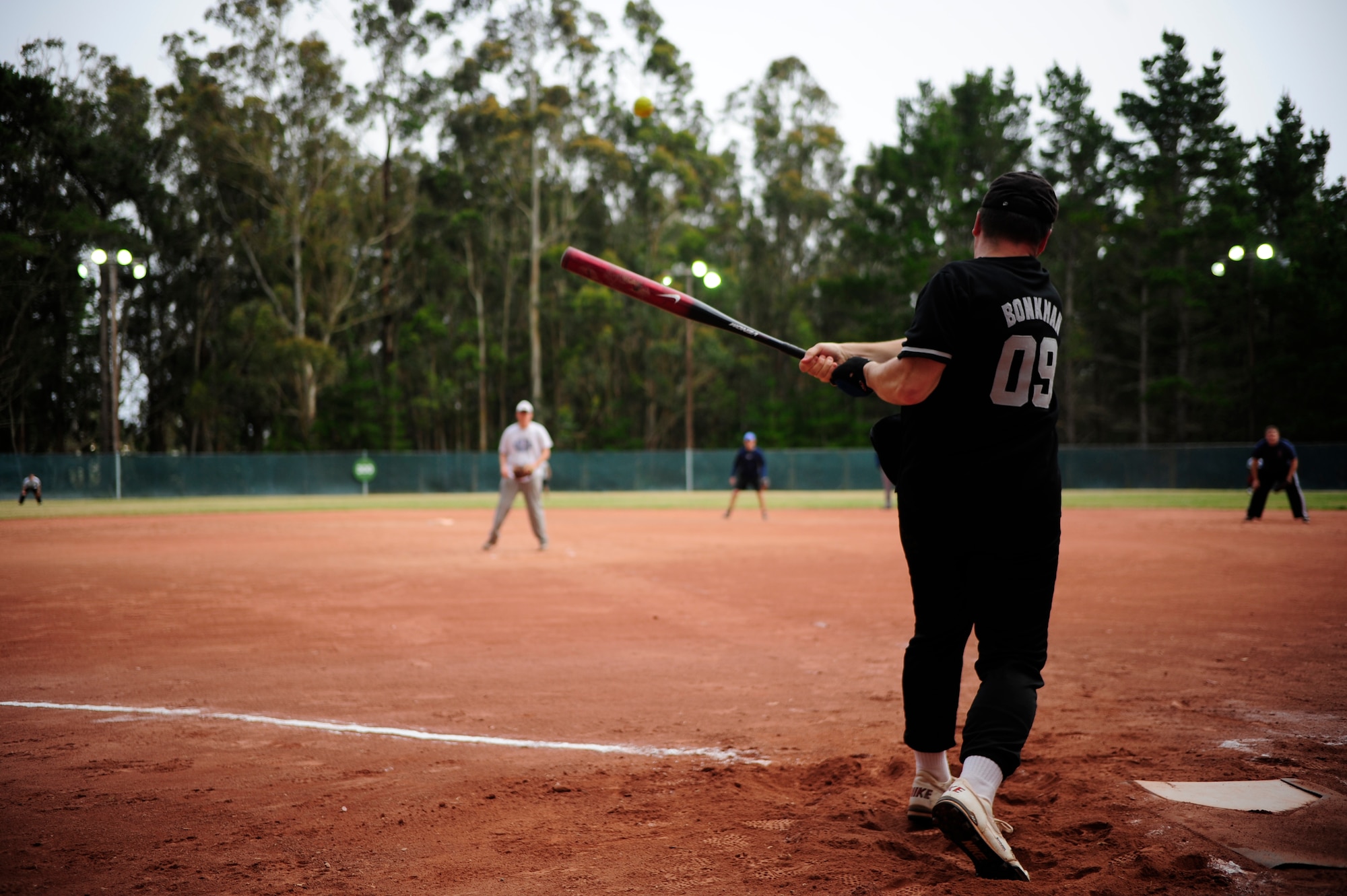 VANDENBERG AIR FORCE BASE, Calif. -- Hitting hard, Scott Renn, a 30th Security Forces Squadron team member, sends a softball into the outfield during a softball game at the baseball field behind the old gym here Tuesday, June 28, 2011.  The 30th SFS team lost the game played against the 381st Training Group team 21-9.  (U.S. Air Force photo/Staff Sgt. Andrew Satran) 

   