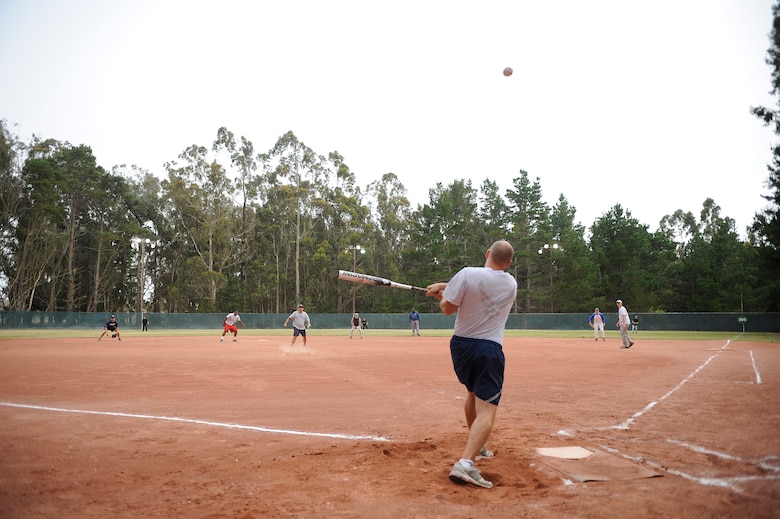 VANDENBERG AIR FORCE BASE, Calif. -- Hitting a fly ball, Scott Romberger, a 381st Training Group team member, sends a softball into the outfield during a softball game at the baseball field here, Tuesday, June 28, 2011.  The 381st TRG defeated the 30th SFS team 21-9.  (U.S. Air Force photo/Staff Sgt. Andrew Satran) 

   