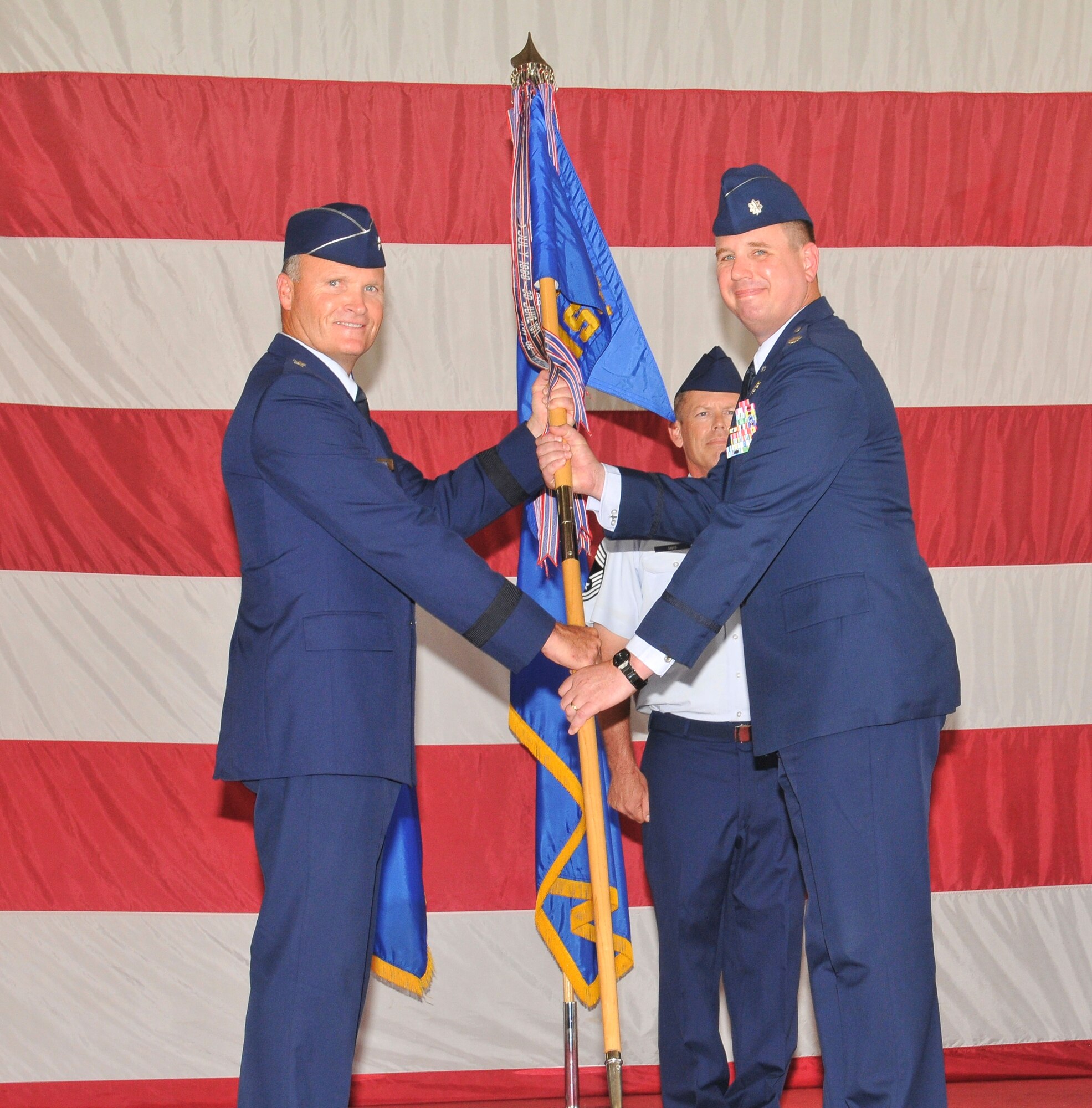 Brigadier Gen. James S. Browne, 325th Fighter Wing commander, passes command of the 325th Mission Support Group to Lt. Col. William Grund during a change of command ceremony June 29.  Colonel Grund replaces Col. Michael Fleck who departs Tyndall for a deployment.  Colonel Grund arrives from Washington D.C., where he served at the Secretary of the Air Force, Officer of Information Dominance and Chief Information Officer Branch.  (U.S. Air Force photo by Lisa Norman)