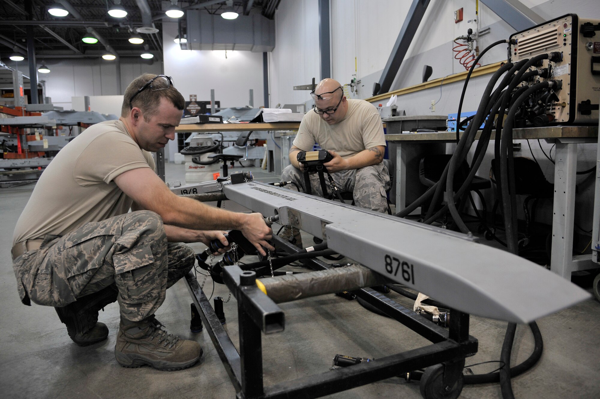 Staff Sgts. Mikel Parrish and Matt Fratzke connect a Stores System Tester to an S-210 launcher during an inspection June 23, 2011, Eielson Air Force Base, Alaska. The SST is used to perform multiple tests simulating munitions dropping from the launcher. Sergeants Parrish and Fratzke are armament technicians assigned to the 354th Maintenance Squadron. (U.S. Air Force photo/Staff Sgt. Christopher Boitz)