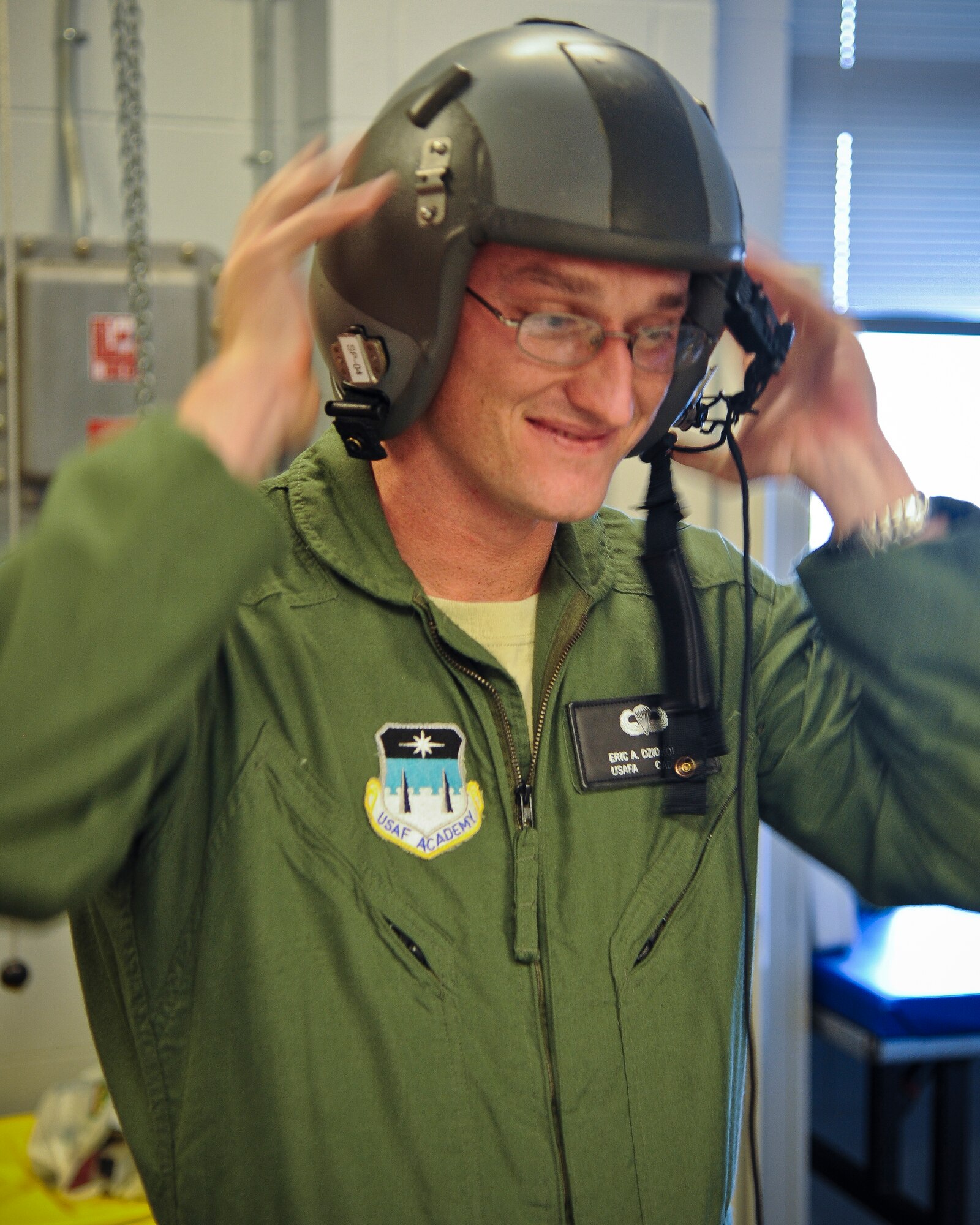 U.S. Air Force Academy cadet Eric Dziokonski tries on head-gear before his flight in an HC-130P Combat King at Moody Air Force Base, Ga., June 28, 2011. Cadet Dziokonski received gear and a pre-flight brief before his night operations flight. (U.S. Air Force photo by Airman 1st Class Paul Francis/Released)