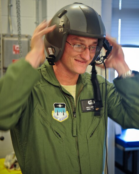 U.S. Air Force Academy cadet Eric Dziokonski tries on head-gear before his flight in an HC-130P Combat King at Moody Air Force Base, Ga., June 28, 2011. Cadet Dziokonski received gear and a pre-flight brief before his night operations flight. (U.S. Air Force photo by Airman 1st Class Paul Francis/Released)
