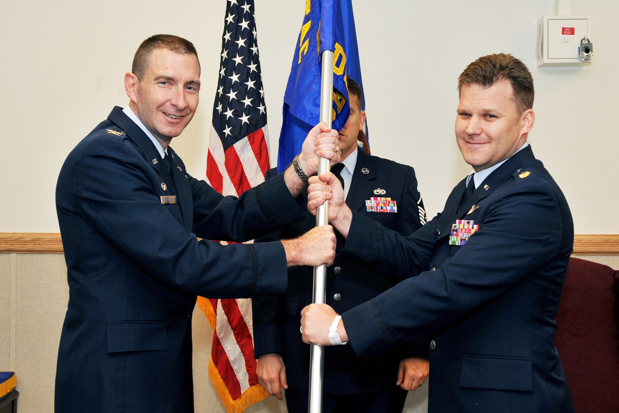 U.S. Air Force Col. Aaron M. Prupas, Air Force Technical Applications Center commander, Patrick Air Force Base, Fla., passes the AFTAC Detachment 1 guidon to incoming commander U.S. Air Force Maj. John Baycura, during a change of command ceremony inside the Martin Bomber Building on Offutt Air Force Base, Neb. on June 29. 

(U.S. Air Force Photo by Charles Haymond/Released)