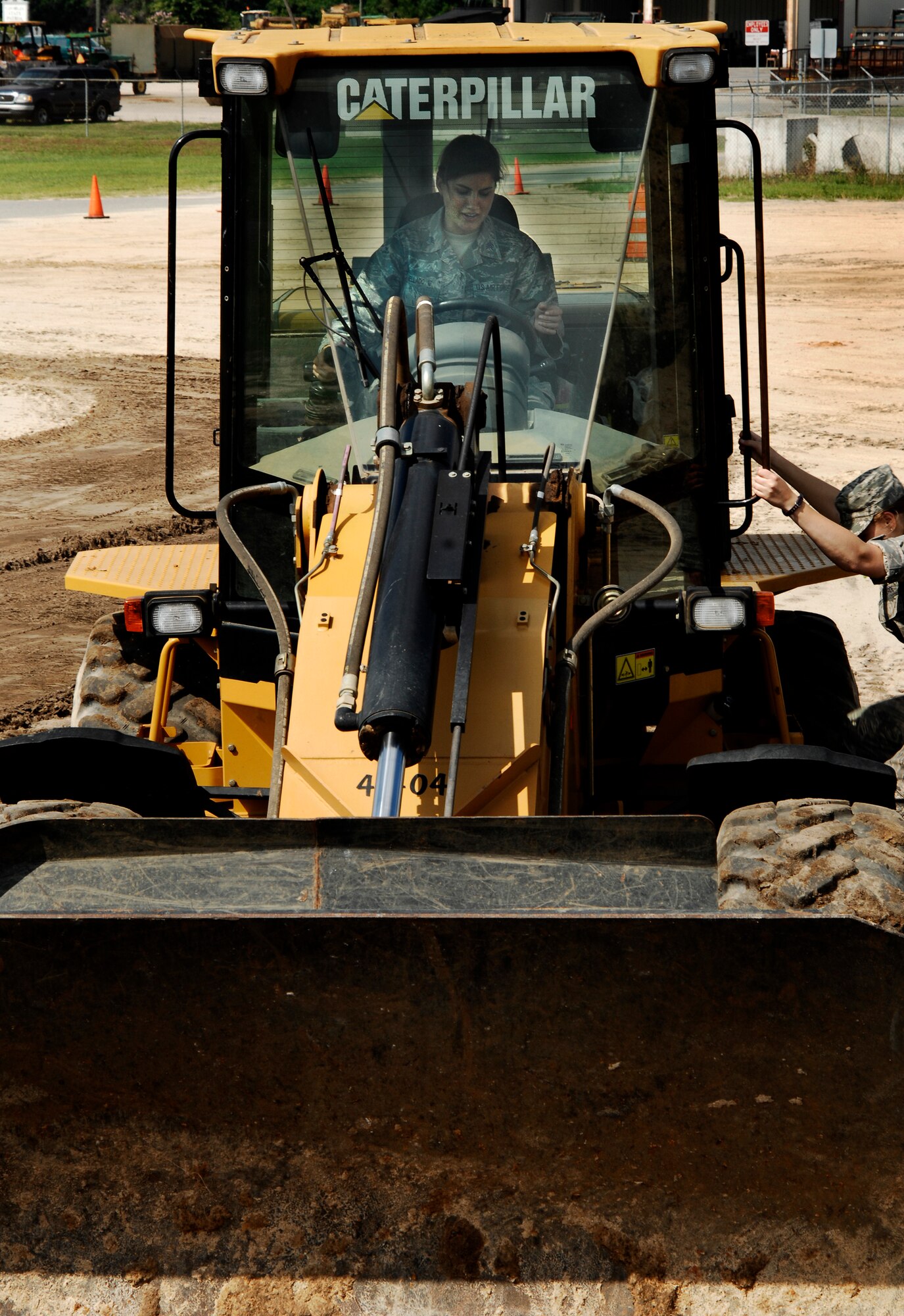 U.S. Air Force Academy Cadet Elisabeth Mellado works a front-end loader at Valdosta Public Works in Valdosta, Ga., June 20, 2011, as part of a community interaction day. The group of six cadets from the Academy visited Moody Air Force Base, Ga., for nearly three weeks to get a taste of operational Air Force life and careers. (U.S. Air Force photo by Airman 1st Class Brigitte N. Brantley/Released)