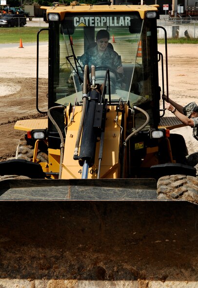 U.S. Air Force Academy Cadet Elisabeth Mellado works a front-end loader at Valdosta Public Works in Valdosta, Ga., June 20, 2011, as part of a community interaction day. The group of six cadets from the Academy visited Moody Air Force Base, Ga., for nearly three weeks to get a taste of operational Air Force life and careers. (U.S. Air Force photo by Airman 1st Class Brigitte N. Brantley/Released)