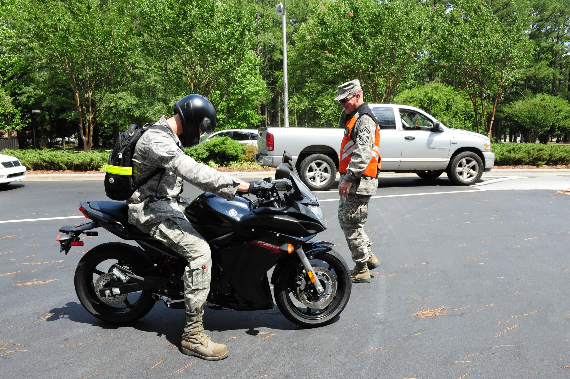 SEYMOUR JOHNSON AIR FORCE BASE, N.C. - Chief Master Sgt. Blake Malpass conducts a walk-around inspection of Senior Airman Harry Weiss' motorcycle during motorcycle safety checks at the Berkeley gate here, June 23, 2011. The checks included looking at the bike's tread wear, lights, asking riders what they should check before riding and possession of the Motorcycle Safety Foundation card that is given upon completion of the motorcycle safety course offered through the base safety office. Chief Malpass, 4th Fighter Wing command chief, hails from Greensboro and Airman Weiss, 336th Specialty Flight, is a native of Vineland, N.J.(U.S. Air Force photo/Senior Airman Rae Perry/RELEASED)