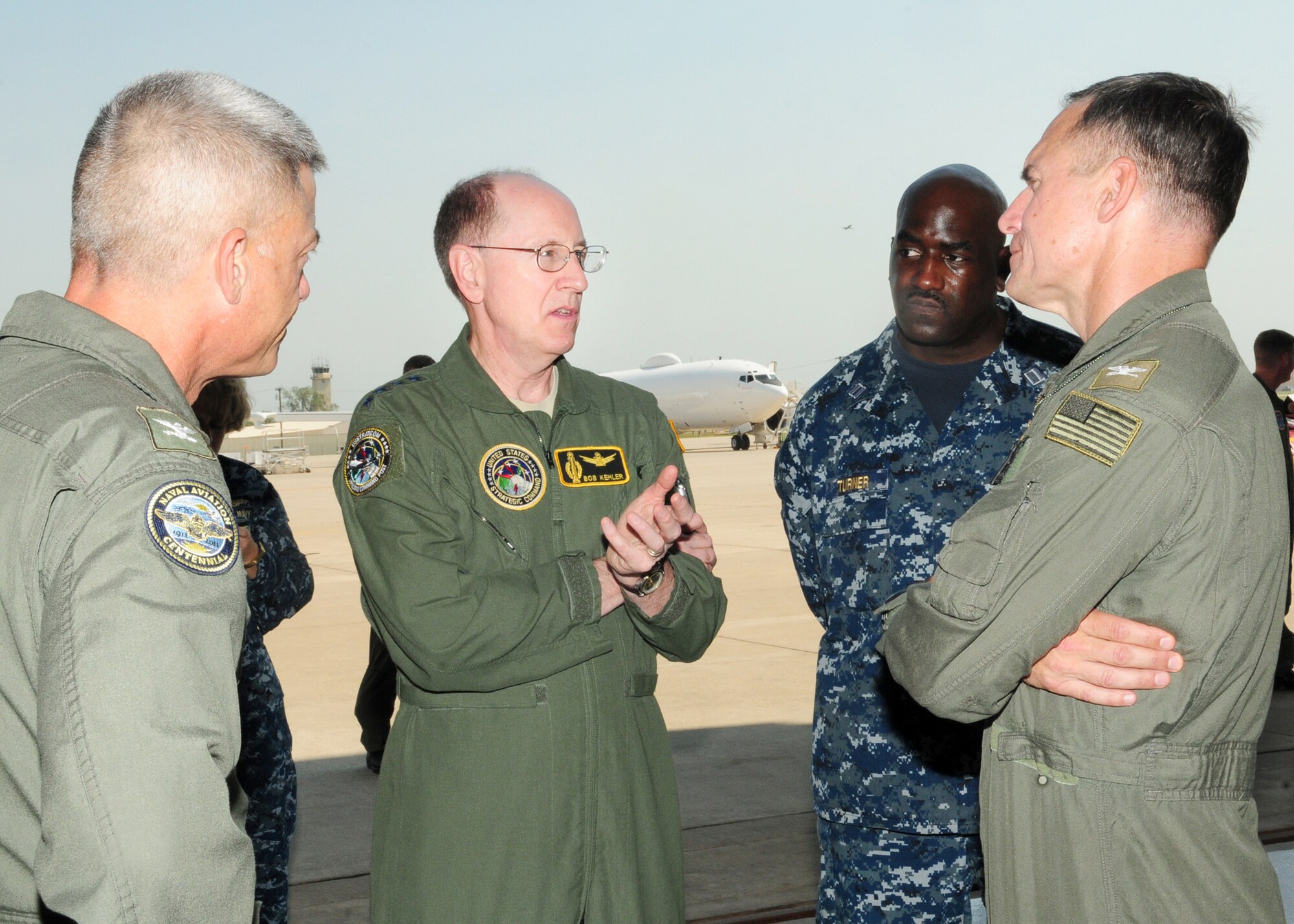 Gen. Robert Kehler, commander of United States Strategic Command, second from left, visited Strategic Communications Wing One June 14. Capt. Charles Baker, SCW-1 deputy wing commander, left; Lt. Roy Turner, wing maintenance officer; and Capt. Tim Pedersen, SCW-1 commander, discuss E-6B maintenance challenges with General Kehler. Captain Pedersen serves as commander of Task Force 124 and reports directly to General Kehler. (Air Force photo by Kelly White)