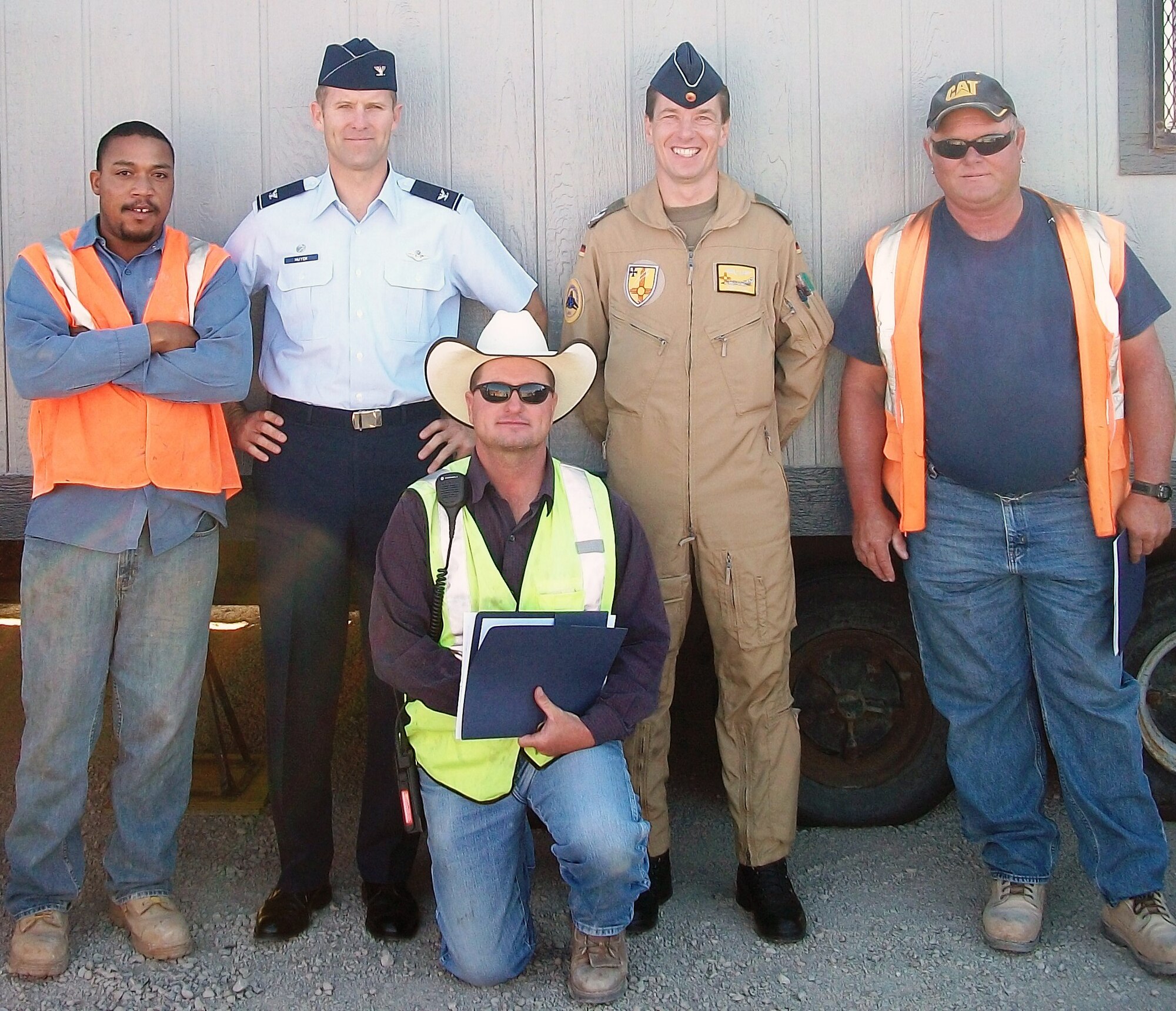 HOLLOMAN AIR FORCE BASE, N.M. -- Col. Kevin Huyck, 49th Wing vice commander, and Lt. Col. Joern Apelt, German Air Force Flying Training Center vice commander, pose for a photo with Kieshawn Vaughus and Cory Gardner, both contracted electricians, and Arnold Adkins, a contracted equipment operator, after Colonel Huyck and Colonel Apelt presented the three contracted workers with a letter of appreciation, June 13, 2011, outside of the Mesa Verde construction compound. The two electricians and equipment operator received the LOAs for their swift actions in dealing with a foreign object debris issue before any Holloman assets were compromised. (Courtesy photo)
