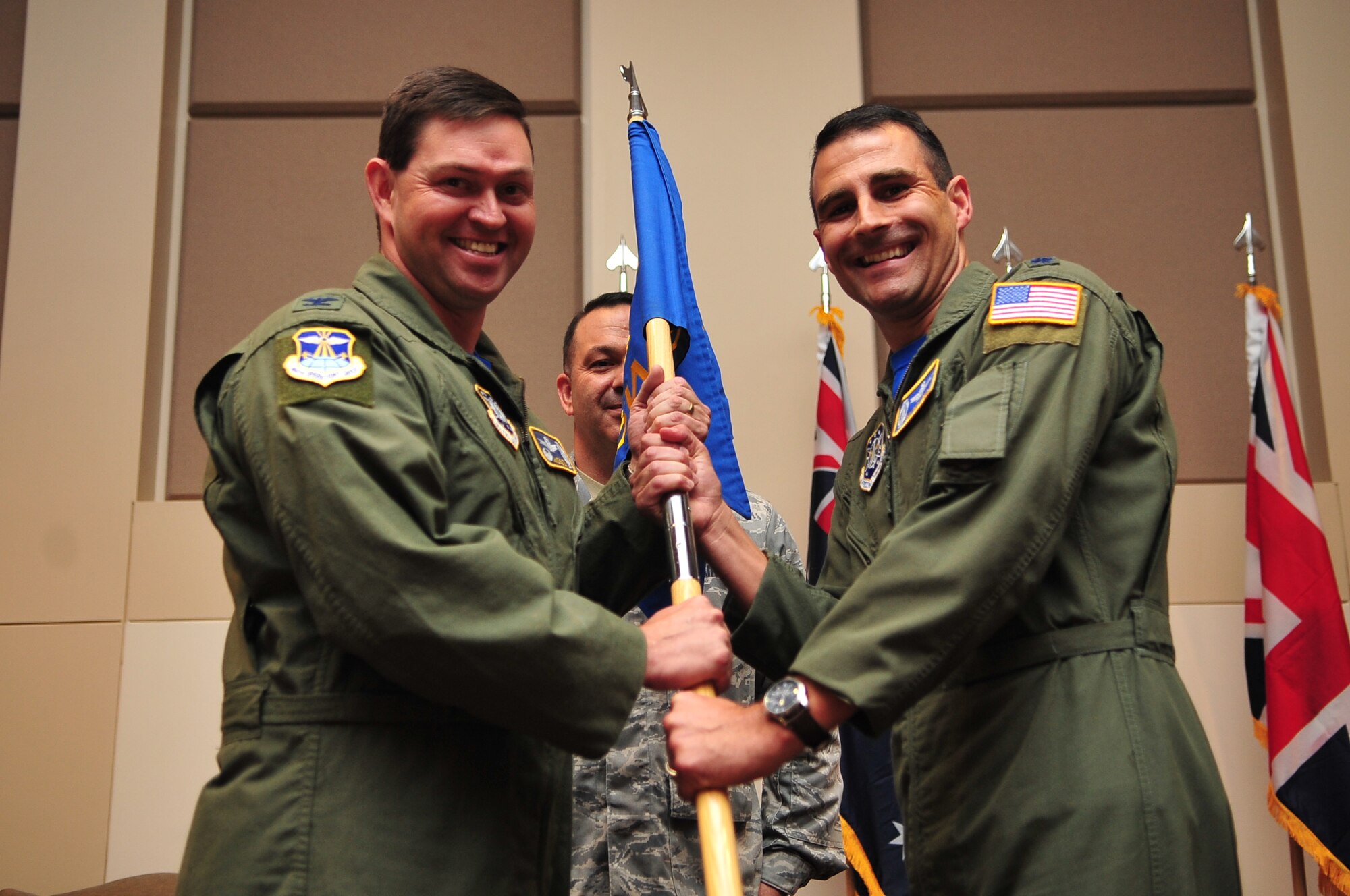 BUCKLEY AIR FORCE BASE, Colo. -- Colonel Bradley Saltzman, 460th Operations Group Commander, presents the flag standard of the 2nd Space Warning Squadron to incoming commander Lt. Col. John Henley June 24, 2011. (U.S. Air Force photo by Staff Sgt. Kathrine McDowell)