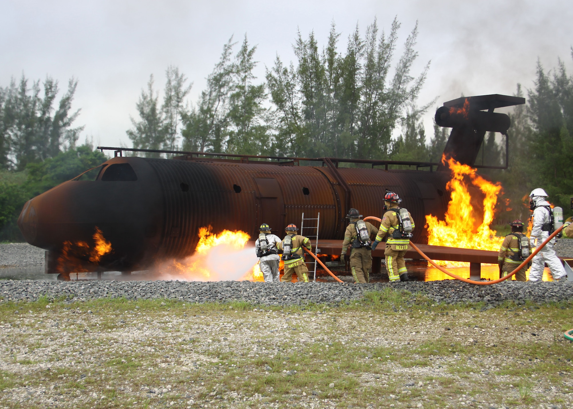 Miami-Dade Fire Rescue and Homestead Air Reserve base firefighters extinguish a mock aircraft fire at the Aircraft Fire Training Facility at Homestead ARB, June 29. The event, part of a two-week series of training, was conducted at the Aircraft Fire Training Facility here on base. The facility simulates a realistic aircraft and can be used for a number of scenarios including liquid fire, cabin fire and engine fire. By conducting the training at Homestead, M.D.F.R. saved a quarter of a million dollars, as opposed to traveling to Dallas, where they had gone in the past. (USAF photo/Mr. Ian Carrier)