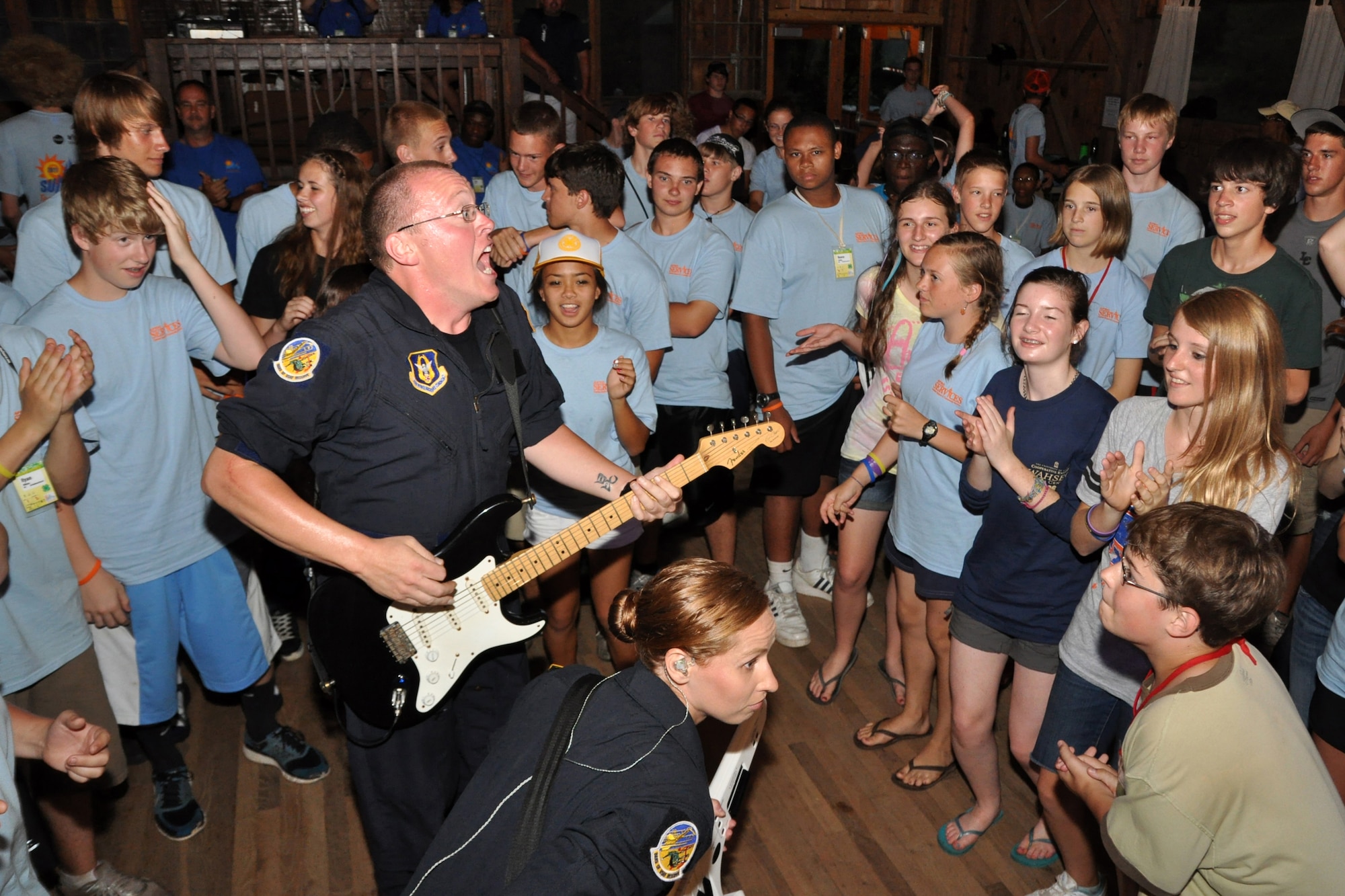 DAHLONEGA, Ga. -- Senior Airman Josh Byrd, guitarist and vocalist in Reserve Generation, a rock band with the Band of the U.S. Air Force Reserve and Airman 1st Class Michelle Cooper, pianist in Reserve Generation,  jam in a surrounding crowd of teens. This concert occurred during the Classic Teen Leadership Summit June 22 at the Wahsega 4-H Center in Dahlonega, Ga. (U.S. Air Force photo/Senior Airman Megan Tomkins)