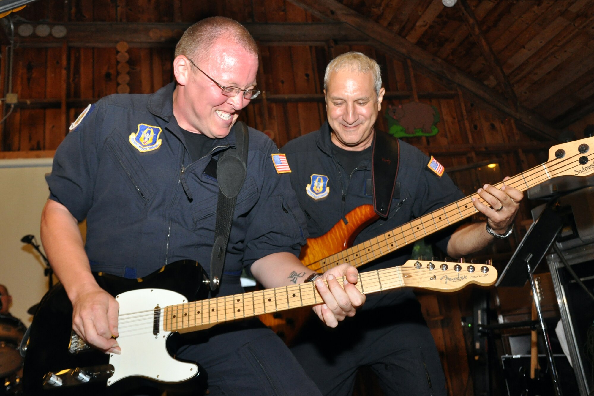 DAHLONEGA, Ga. -- Senior Airman Josh Byrd, guitarist and vocalist in Reserve Generation, a rock band with the Band of the U.S. Air Force Reserve and Master Sgt. Doug Tejada, bassist in Reserve Generation, rock out together as they perform for participants of the Classic Teen Leadership Summit. The Summit took place June 22 at the Wahsega 4-H Center in Dahlonega, Ga. (U.S. Air Force photo/Senior Airman Megan Tomkins)