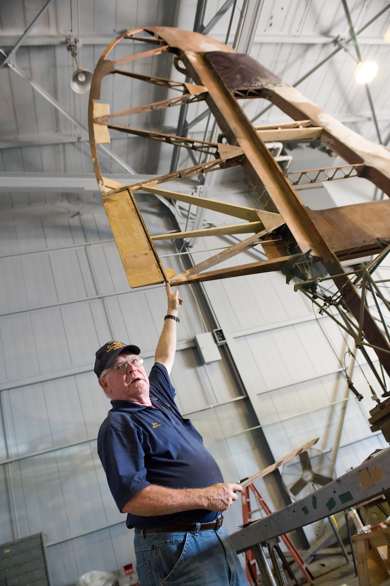Gene Williams, a restoration volunteer, demonstrates the newly constructed tail of a Waco CG-4A Combat Glider June 23, 2011, at the Air Mobility Command Museum at Dover Air Force Base, Del. The glider is being completely restored from scrap. (U.S. Air Force photo/Steve Kotecki)
