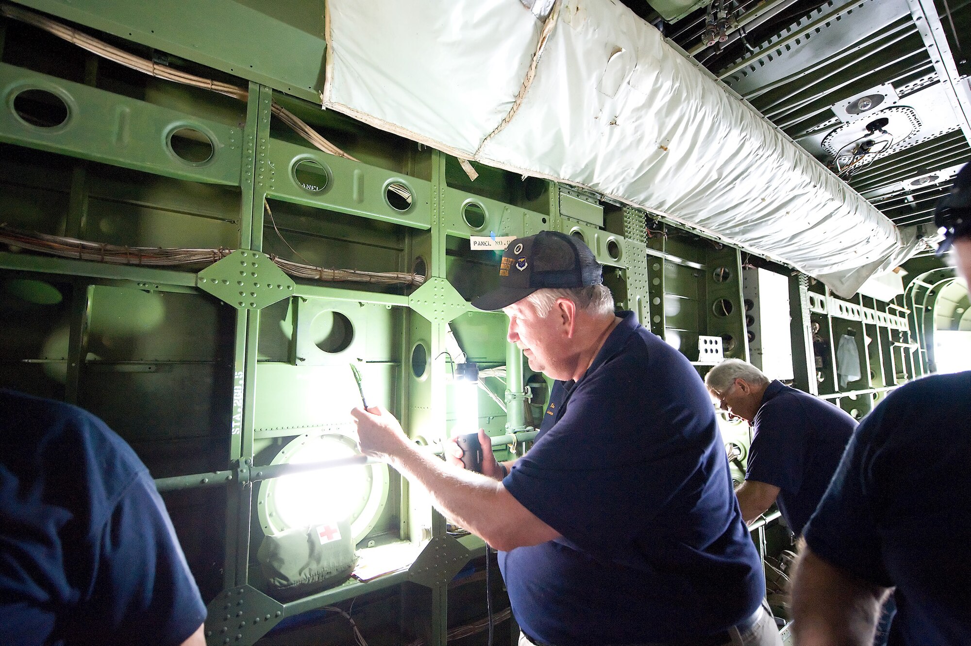 Mike Wood, a restoration volunteer, paints the interior of a C-119 Flying Boxcar June 23, 2011, at the Air Mobility Command Museum on Dover Air Force Base, Del. Mr. Wood is one of more than 100 volunteers at the AMC Museum. (U.S. Air Force photo/Steve Kotecki)
