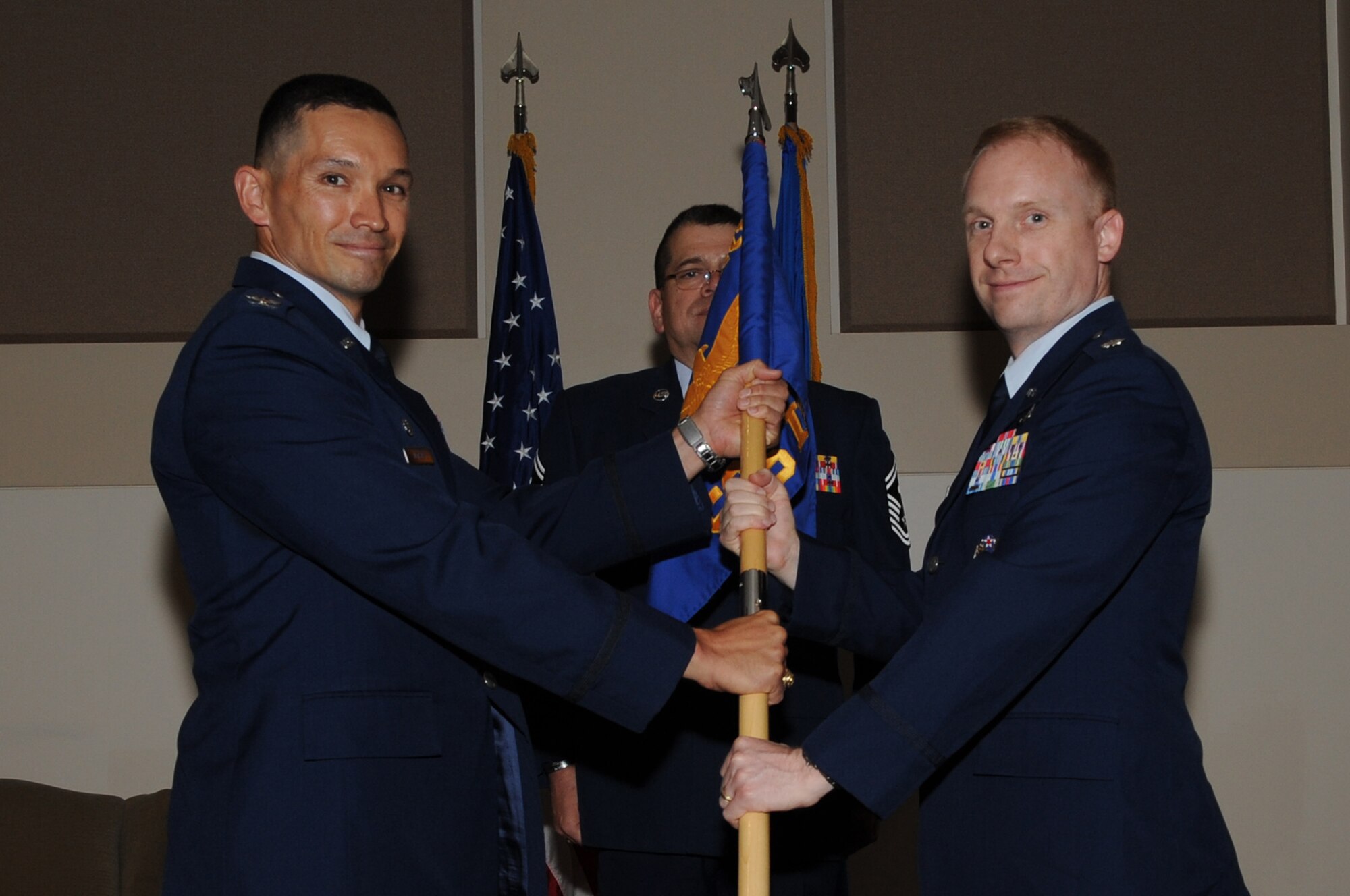 BUCKLEY AIR FORCE BASE, Colo. -- Colonel Thomas Hensley, 544th Intelligence, Surveillance and Reconnaisance Group commander, left, presents the flag standard of the 566th Intelligence Squadron to the incoming commander, Lt. Col. Adam Stone, June 24, 2011. (U.S. Air Force photo by Airman 1st Class Phillip Houk)