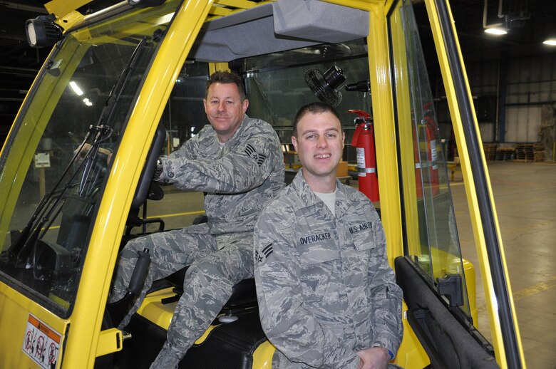 WRIGHT-PATTERSON AIR FORCE BASE, Ohio - Tech. Sgt. Roger Dils and Senior Airman Matt Overacker, 87th Aerial Port Squadron, pose with a forklift in the APS warehouse. The third member of the trio, Tech. Sgt. Mike Maurer is currently deployed.  (U.S. Air Force photo/Master Sgt. Charlie Miller)