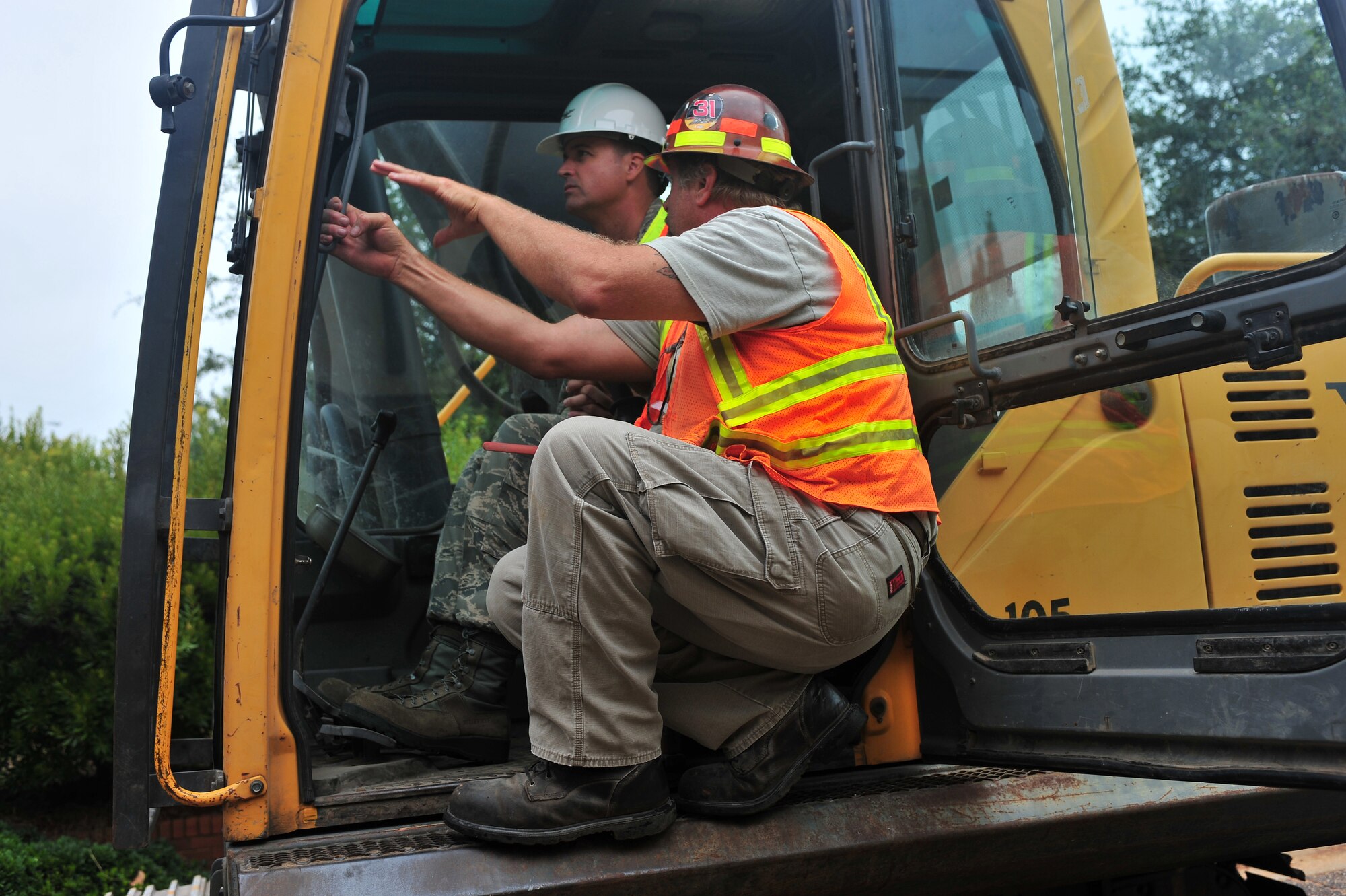 SHAW AIR FORCE BASE, S.C. -- Col. Charlie Moore, 20th Fighter Wing commander, is instructed by a construction worker on how to use a crane June 24, 2011. In order to construct new buildings on Shaw Air Force Base, old abandoned buildings have to be demolished. This demolition is only one of the progressive changes to the base. (U.S. Air Force photo by Airman 1st Class Ashley Gardner/ Released)