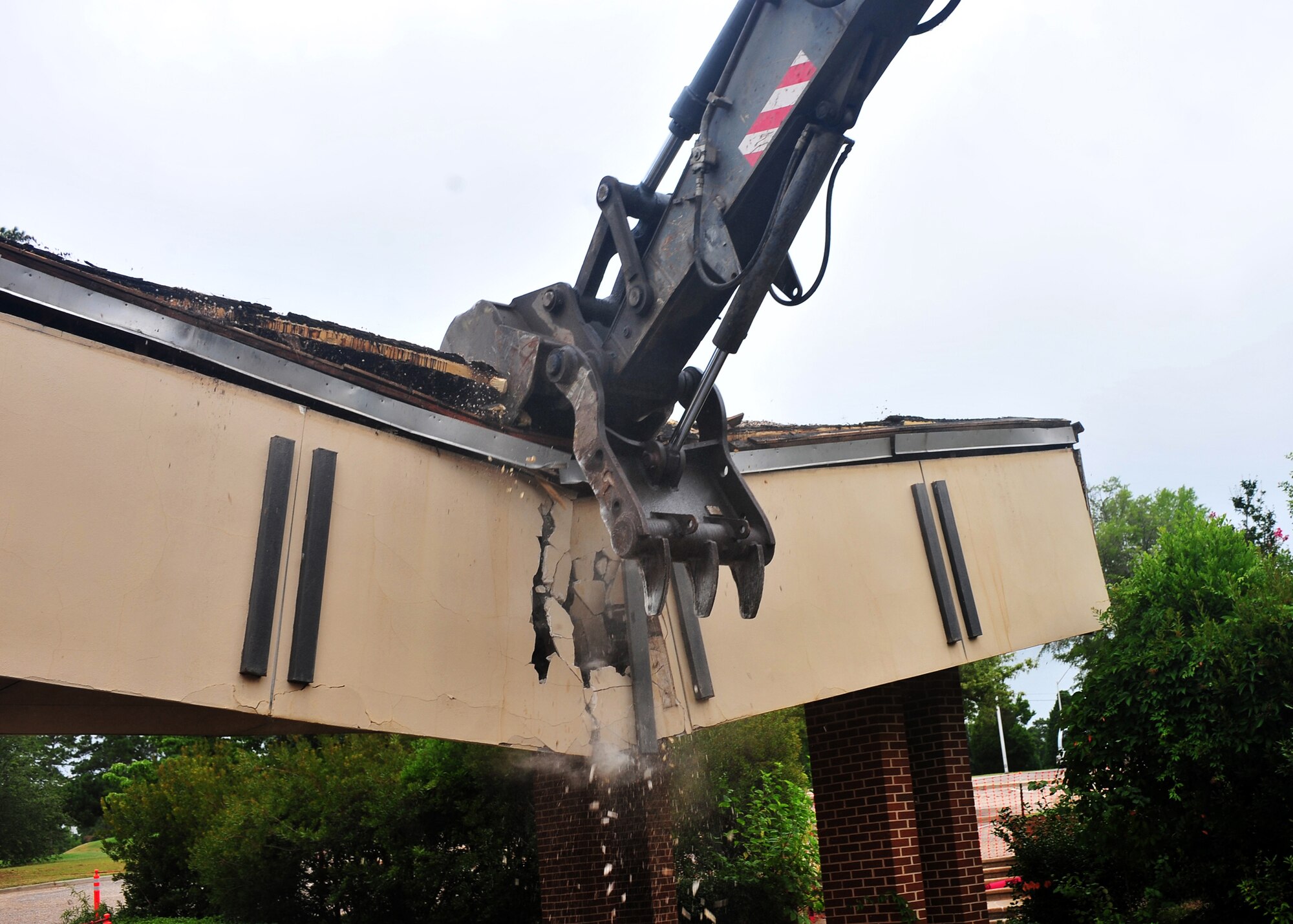 SHAW AIR FORCE BASE, S.C. -- The old noncommissioned officer club comes down after being hit by a crane at full force June 24, 2011. In order to construct new buildings on Shaw Air Force Base, old abandoned buildings have to be demolished. This demolition is only one of the progressive changes to the base. (U.S. Air Force photo by Airman 1st Class Ashley Gardner/ Released)
