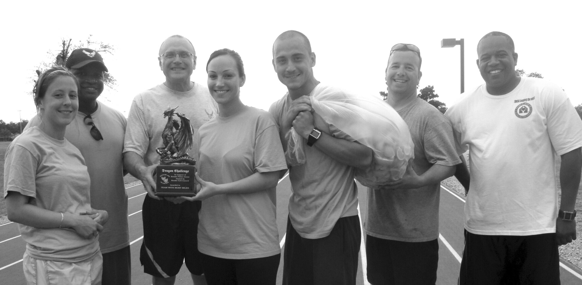 From left, Zsuzsanna Krokovay, Jermain Smith, Brig. Gen. Andrew Mueller, Kayla Spiel, Aleksandar Petrakov, Striggow and Chief Master Sergeant Curtis Jennings. Krokovay, Smith, Spiel and Petrakov represented the Mach 12 team that tallied 255½ miles. General Mueller is the 81st Training Wing commander, Striggow is the Keesler 5/6 president and Chief Jennings is the wing’s command chief. (Courtesy photo)