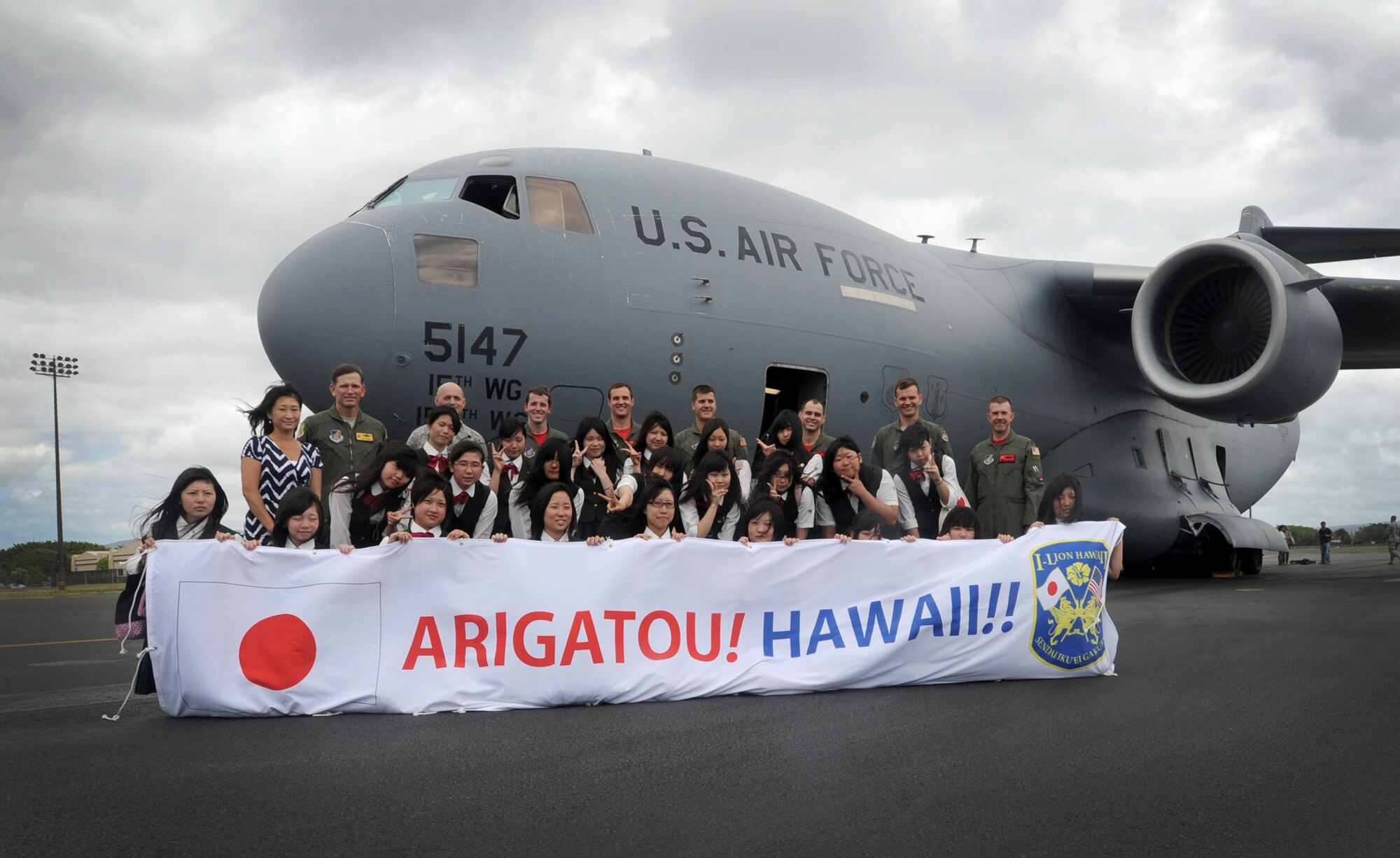 High school students from Sendai ,Japan, pose for a photo in front of a C-17 Globemaster III during a base tour June 24, 2011, at Joint Base Pearl Harbor-Hickam. The students are from Sendai Ikuei Gakuen High School in Japan and are continuing their education in Hawaii while their homes and school are being rebuilt. The students came to Joint Base Pearl Harbor-Hickam to tour the base and meet the C-17 crew who flew to Sendai following the earthquake and tsunami. (U.S. Air Force photo/Senior Airman Lauren Main)