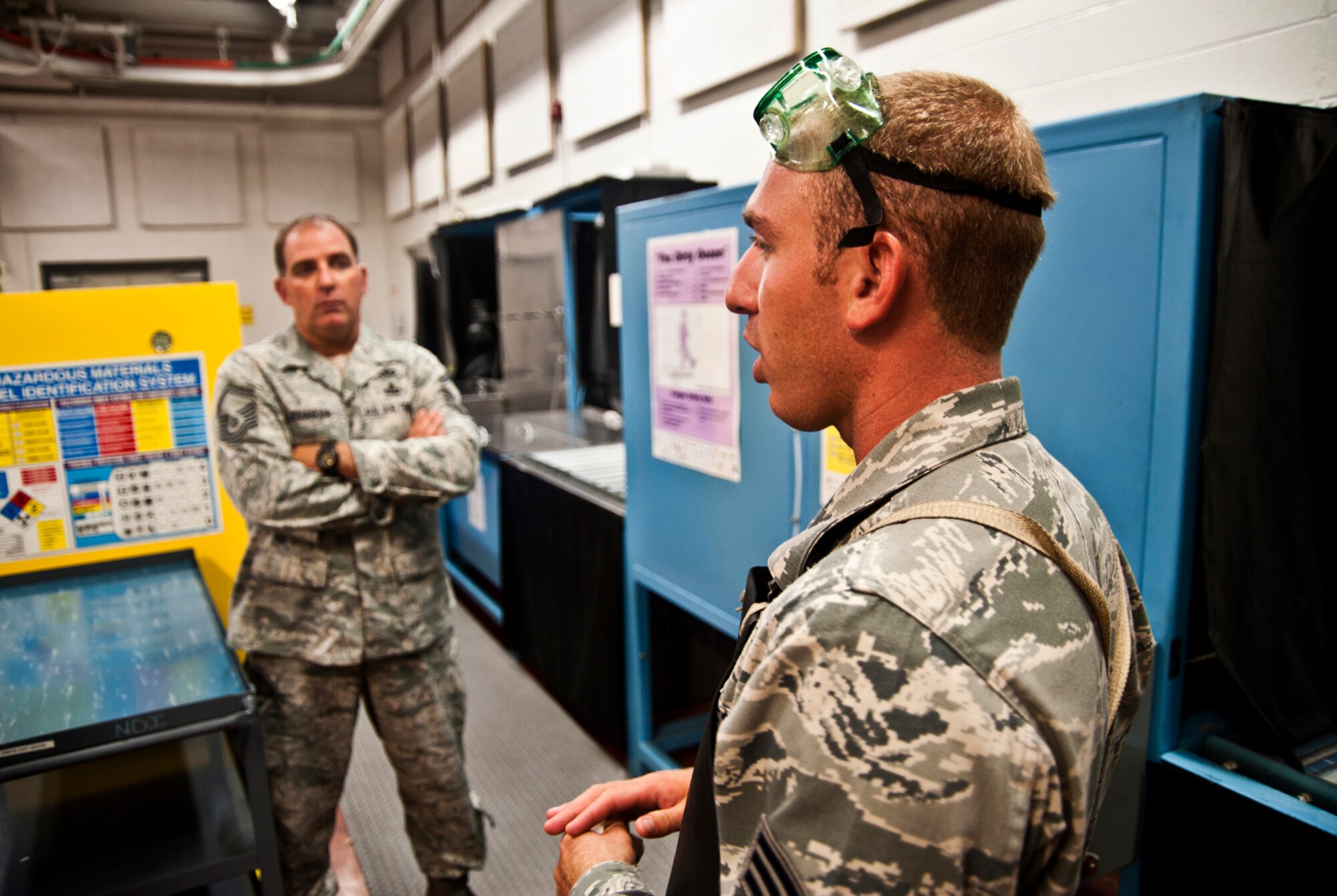 Senior Master Sergeant Bradley Levander Sr. stands by while his son, Senior Airman Bradley Levander Jr., gives instruction on non destructive inspection procedures in the main bay at the 315th Maintenance Squadron located at Joint Base Charleston, S.C on June 22, 2011. Both Sgt. Levander and his son are assigned to the 315th Airlift Wing at Joint Base Charleston, S.C. (U.S. Air Force Photo/SSgt. Andrew Caya)