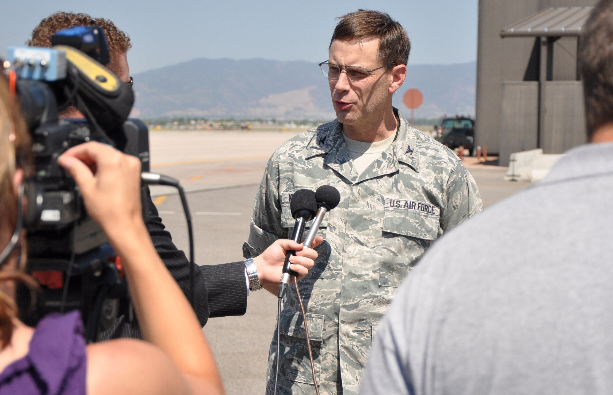 Col. James Van Housen, maintenance group commander for the 302nd Airlift Wing talks with Colorado Springs media after two Modular Airborne Fire Fighting System-equipped C-130s departed here for Kirtland Air Force Base, N.M. The two planes and 26 reservists will assist in wildland fire-fighting efforts in New Mexico and Arizona. (U.S. Air Force photo/Tech. Sgt. Daniel Butterfield) 