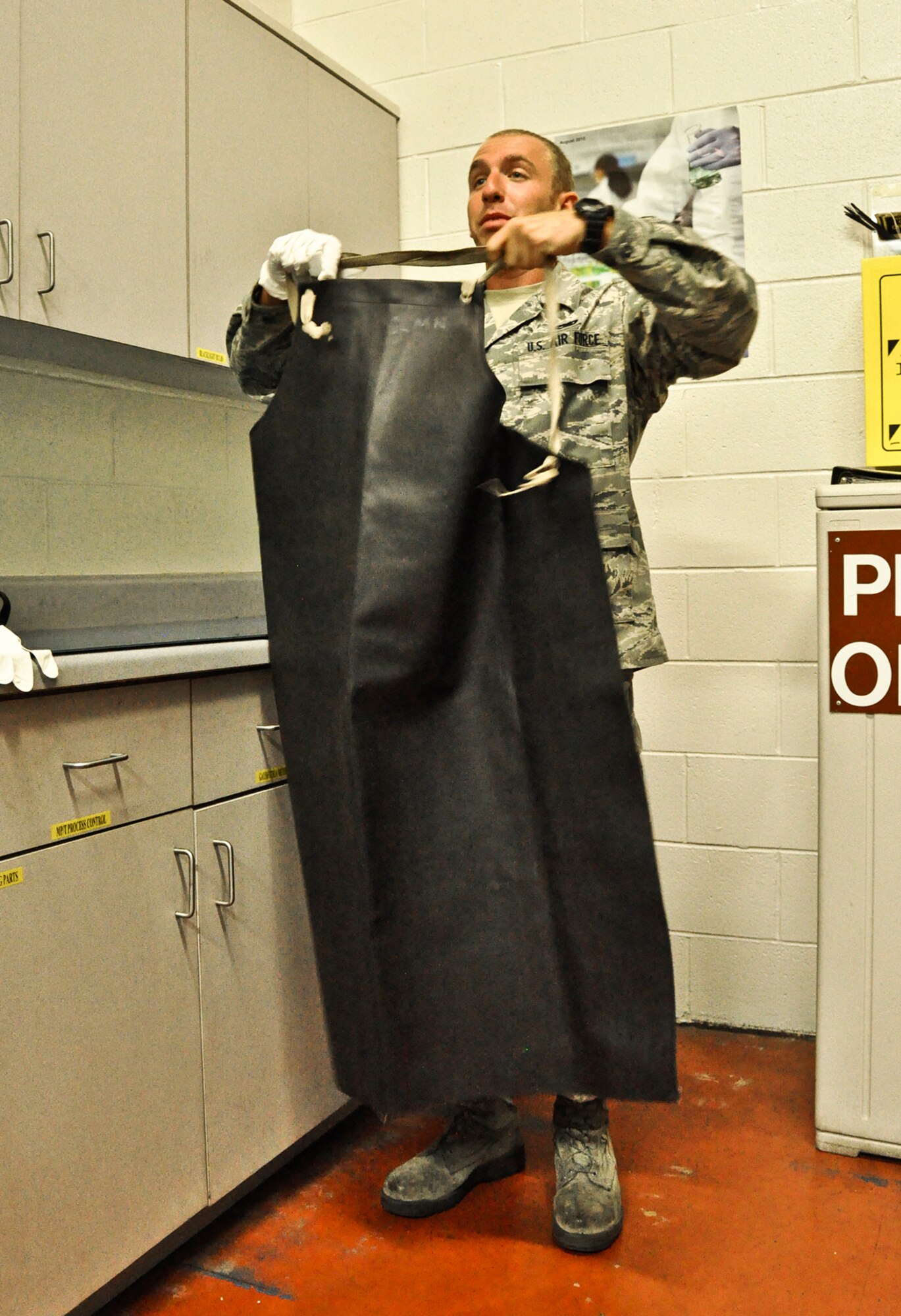 Senior Airman Bradley Levander Jr. dons his protective gear in preparation for the day's work on June 22, 2011 at Joint Base Charleston, S.C. Airman Levander is assigned to the 315th Maintenance Squadron at Joint Base Charleston, S.C. (U.S. Air Force Photo/SSgt. Rashard Coaxum)