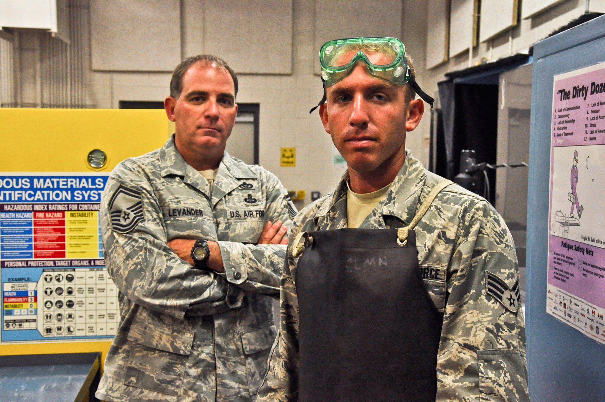 Senior Airman Bradley Levander Jr. stands with his father, Senior Master Sergeant Bradley Levander Sr., in the maintenance bay at the 315th Maintenance Squadron building on June 22, 2011 at Joint Base Charleston, S.C. Airman Levander is a non destructive inspection apprentice assigned to the 315th Maintenance Squadron while Sgt. Levander is a senior air reserve technician assigned to the 81st Aerial Port Squadron. (U.S. Air Force Photo/SSgt. Rashard Coaxum)