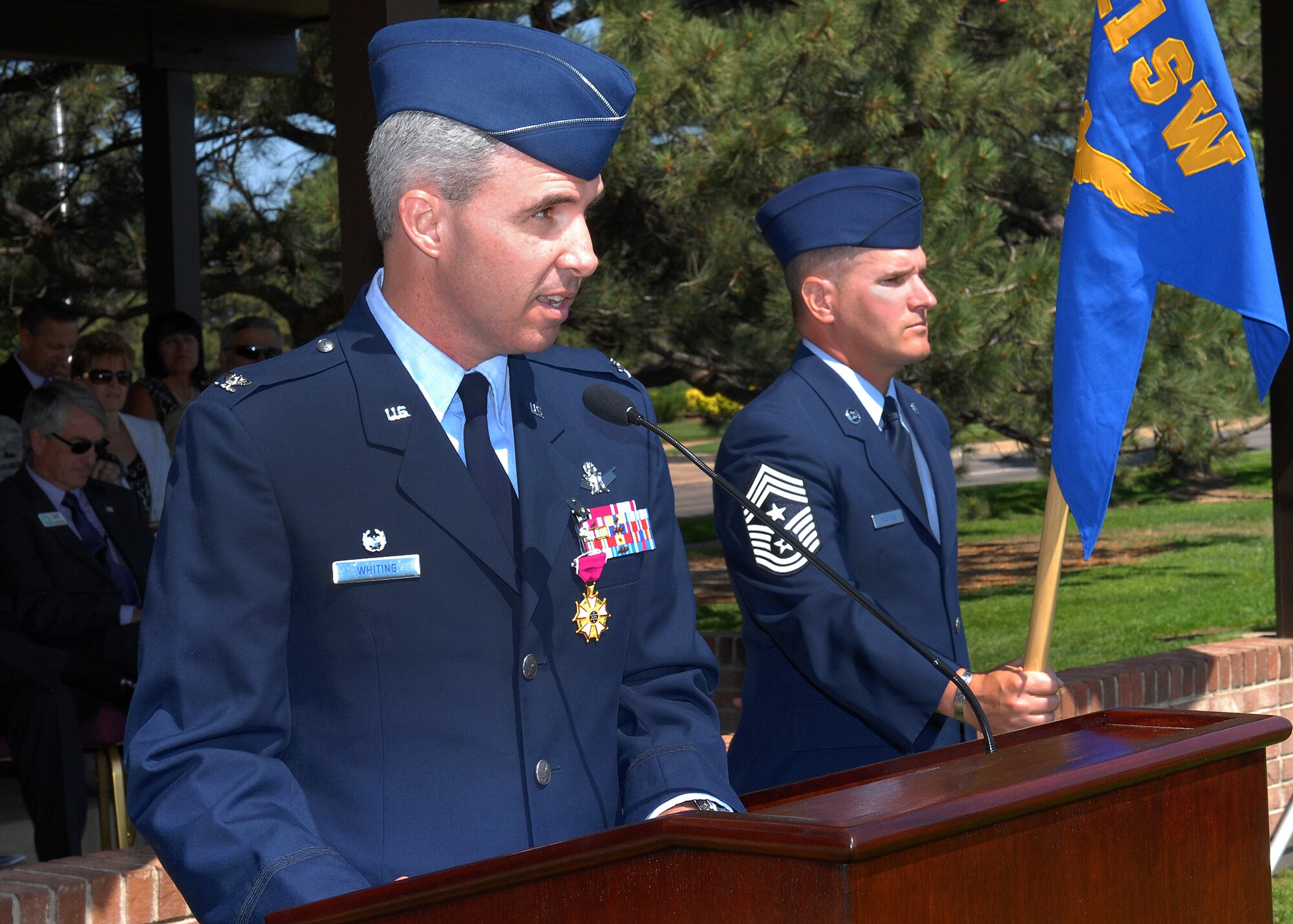 Col. Stephen N. Whiting (left) addresses a formation of wing Airmen and an audience of wing members, base personnel and civilian partners during a change of command ceremony here June 28. Colonel Whiting relinquished command of the 21st Space Wing to Col. Chris Crawford. This is Colonel Crawford’s fifth time assigned to Colorado Springs, and third time assigned with the 21st SW. (U.S. Air Force photo/Rob Bussard)