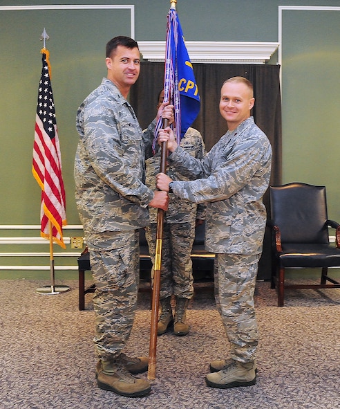 SHAW AIR FORCE BASE, S.C. -- U.S. Air Force 20th Fighter Wing commander Col. Charles Moore, left, passes the 20th Comptroller squadron flag to Maj. Kile Dreher, the new commander of the 20th CPTS during the change of command ceremony Jun. 20, 2011. Major Dreher took command from Maj. Simon Scoggins, who led the squadron from June 20, 2008 to July 1, 2011. (U.S. Air Force photo by A1C Neil D. Warner/Released)