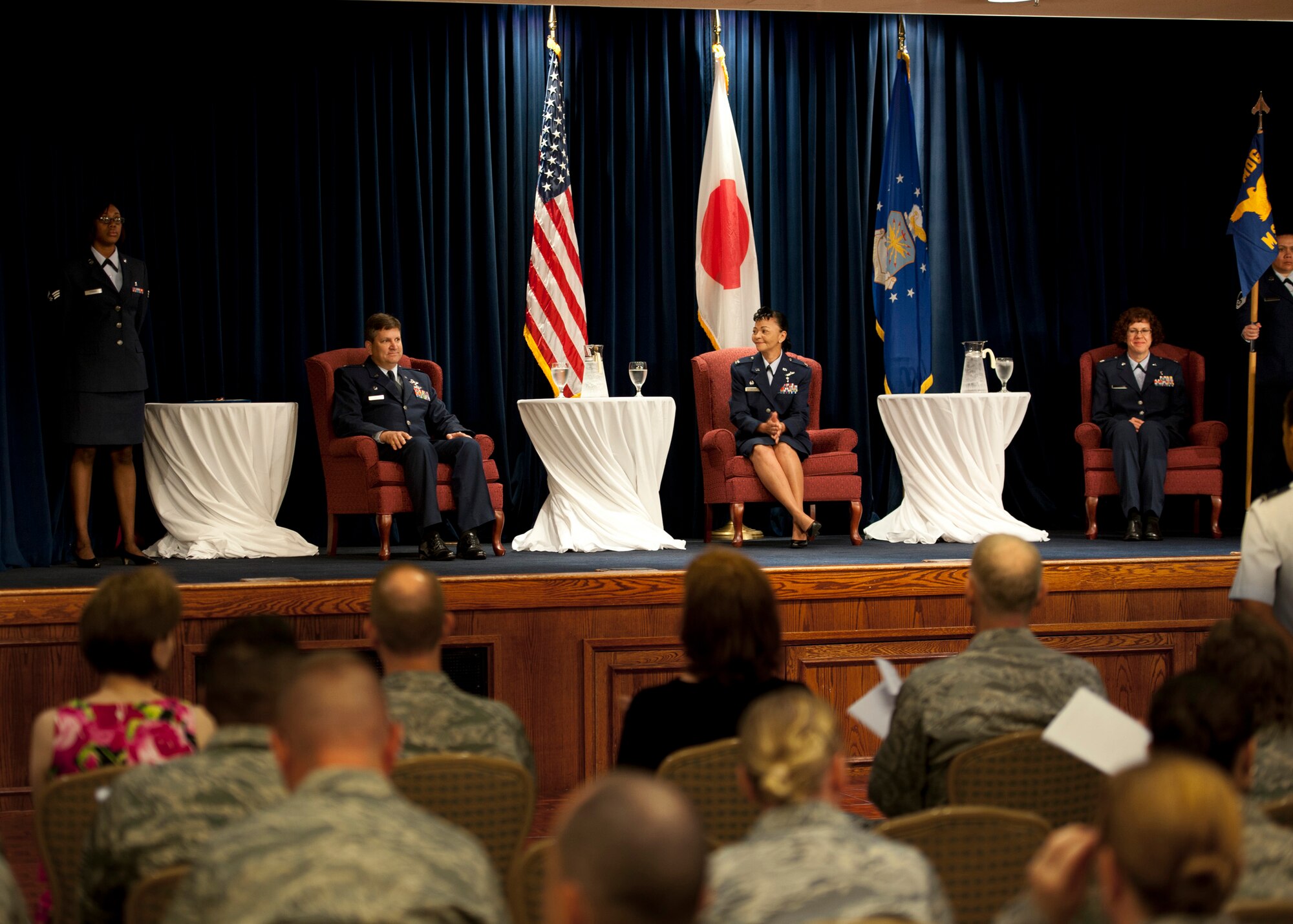 YOKOTA AIR BASE, Japan -- (from left to right) Col. (Dr.) Lee Harvis, 374th Medical Group commander; Col. Christine Taylor, the outgoing 374th Medical Surgical Squadron commander; and Lt. Col. Jill O'Rear, the incoming 374th MSGS commander;  sit on stage at the start of the change of command ceremony here June 23, 2011. (U.S. Air Force photo/Staff Sgt. Samuel Morse)