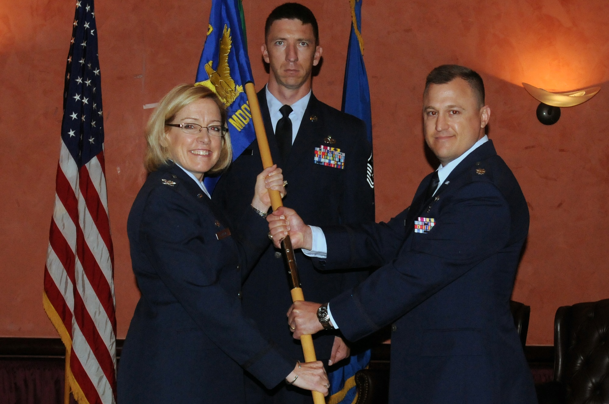 Col. Linda L. Lawrence, 31st Medical Group commander, passes the 31st Medical Operations Squadron guidon to Lt. Col. Guy R. Majkowski, during the 31st MDOS change of command ceremony June 24 at Aviano Air Base, Italy. Colonel Majkowski took the rein of the 31st MDOS from Lt. Col. Scott B. Holliday after working as the deputy director of the commanders' action group in the Office of the Surgeon General at the Pentagon.(U.S. Air Force photo/Airman LaVel Sterling)