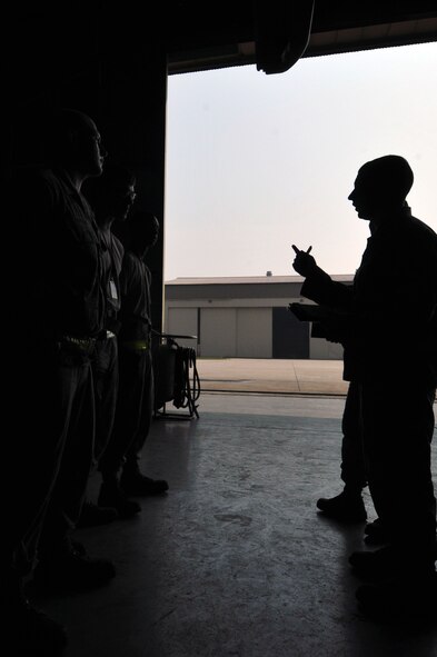 KUNSAN AIR BASE, Republic of Korea -- Senior Airman Ryan Castle, 8th Maintenance Operations Squadron load crew member evaluator, after assessing a load crew from the 80th Aircraft Maintenance Squadron, tells the crew their overall performance. The 8th Maintenance Group provides on- and off-equipment maintenance on F-16 Fighting Falcons. The group also provides munitions, aircraft maintenance and maintenance operations support. (U.S. Air Force photo/Senior Airman Brittany Y. Bateman)
