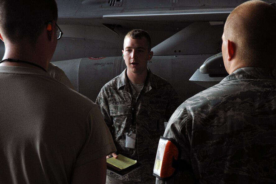 KUNSAN AIR BASE, Republic of Korea -- Senior Airman Ryan Castle, 8th Maintenance Operations Squadron load crew member evaluator, after assessing a load crew from the 80th Aircraft Maintenance Squadron tells the crew their overall performance. Load crews are evaluated and have to qualify quarterly. (U.S. Air Force photo/Senior Airman Brittany Y. Bateman)