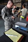 KUNSAN AIR BASE, Republic of Korea -- Senior Airman Ryan Castle, 8th Maintenance Operations Squadron load crew member evaluator, assesses a load crew from the 80th Aircraft Maintenance Squadron. The 8th Maintenance Group provides on- and off-equipment maintenance on F-16 Fighting Falcons. The group also provides munitions, aircraft maintenance and maintenance operations support.  (U.S. Air Force photo/Senior Airman Brittany Y. Bateman)