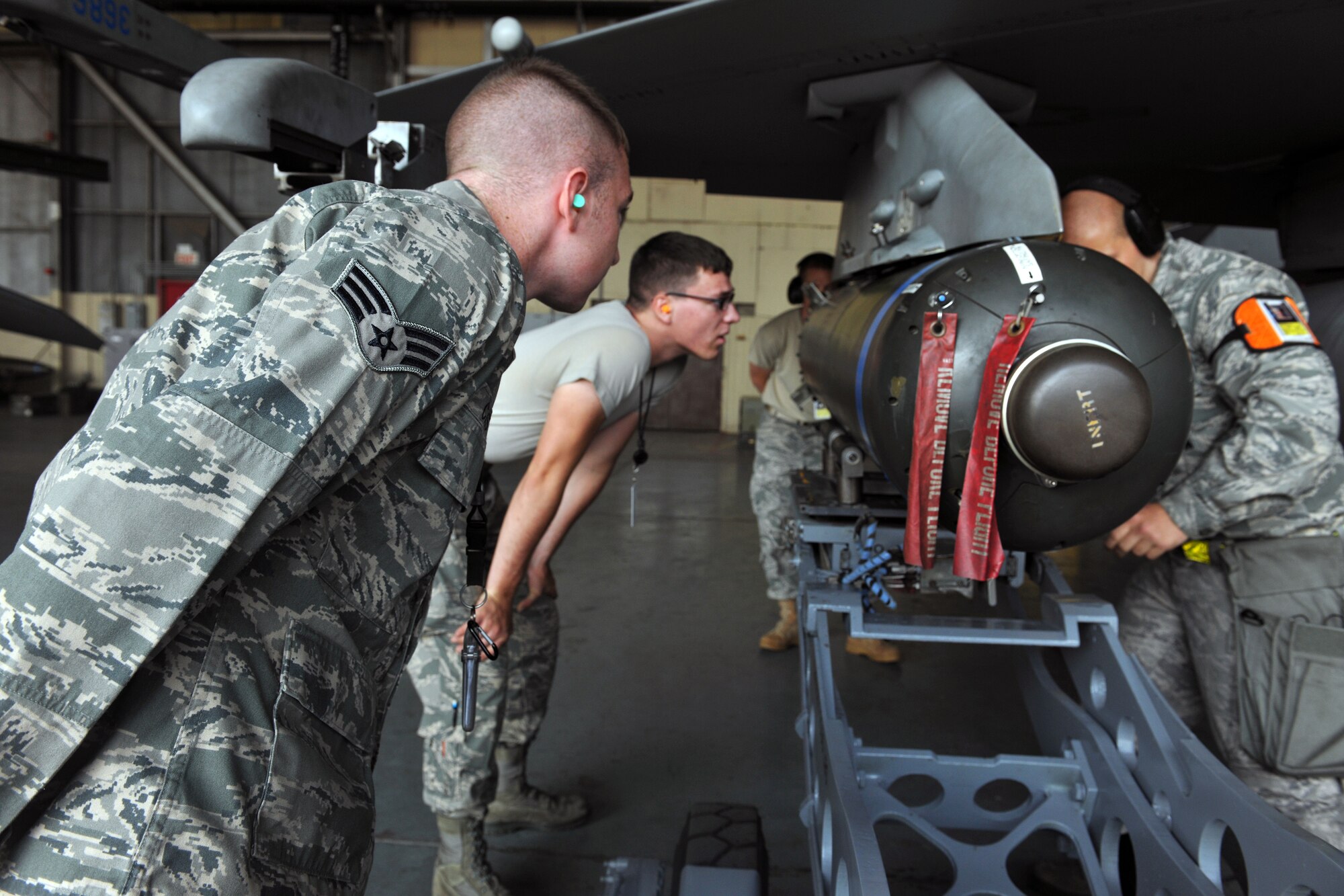 KUNSAN AIR BASE, Republic of Korea -- Senior Airman Ryan Castle, 8th Maintenance Operations Squadron load crew member evaluator, assesses a load crew from the 80th Aircraft Maintenance Squadron. Load crews are evaluated and have to qualify quarterly. (U.S. Air Force photo/Senior Airman Brittany Y. Bateman) 