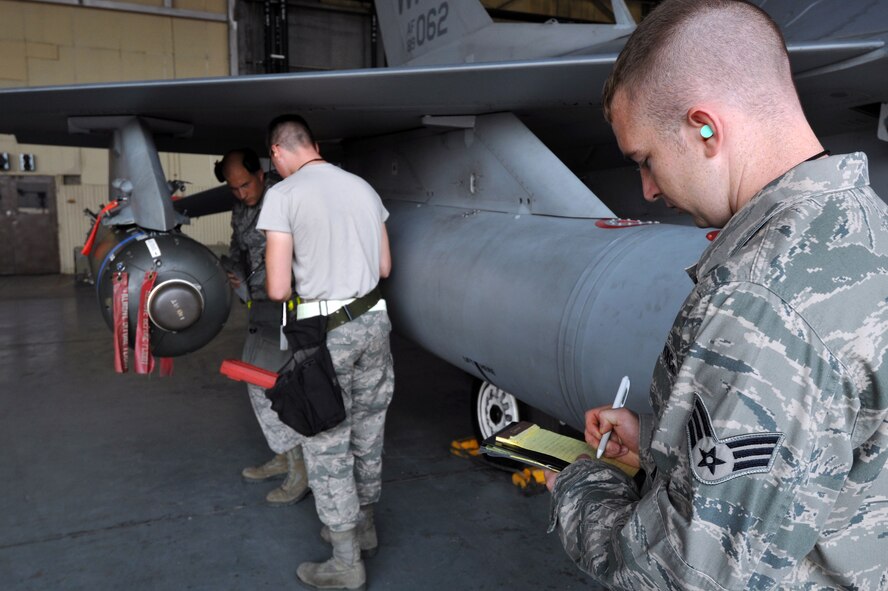 KUNSAN AIR BASE, Republic of Korea -- Senior Airman Ryan Castle, 8th Maintenance Operations Squadron load crew member evaluator, assesses a load crew from the 80th Aircraft Maintenance Squadron. Load crews are evaluated and have to qualify quarterly. (U.S. Air Force photo/Senior Airman Brittany Y. Bateman) 