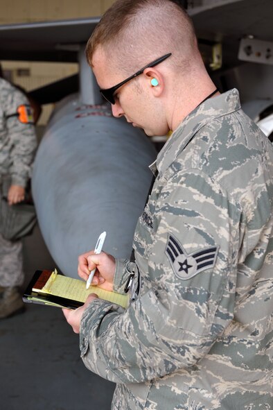 KUNSAN AIR BASE, Republic of Korea -- Senior Airman Ryan Castle, 8th Maintenance Operations Squadron load crew member evaluator, assesses a load crew from the 80th Aircraft Maintenance Squadron. Load crews are evaluated and have to qualify quarterly. (U.S. Air Force photo/Senior Airman Brittany Y. Bateman) 