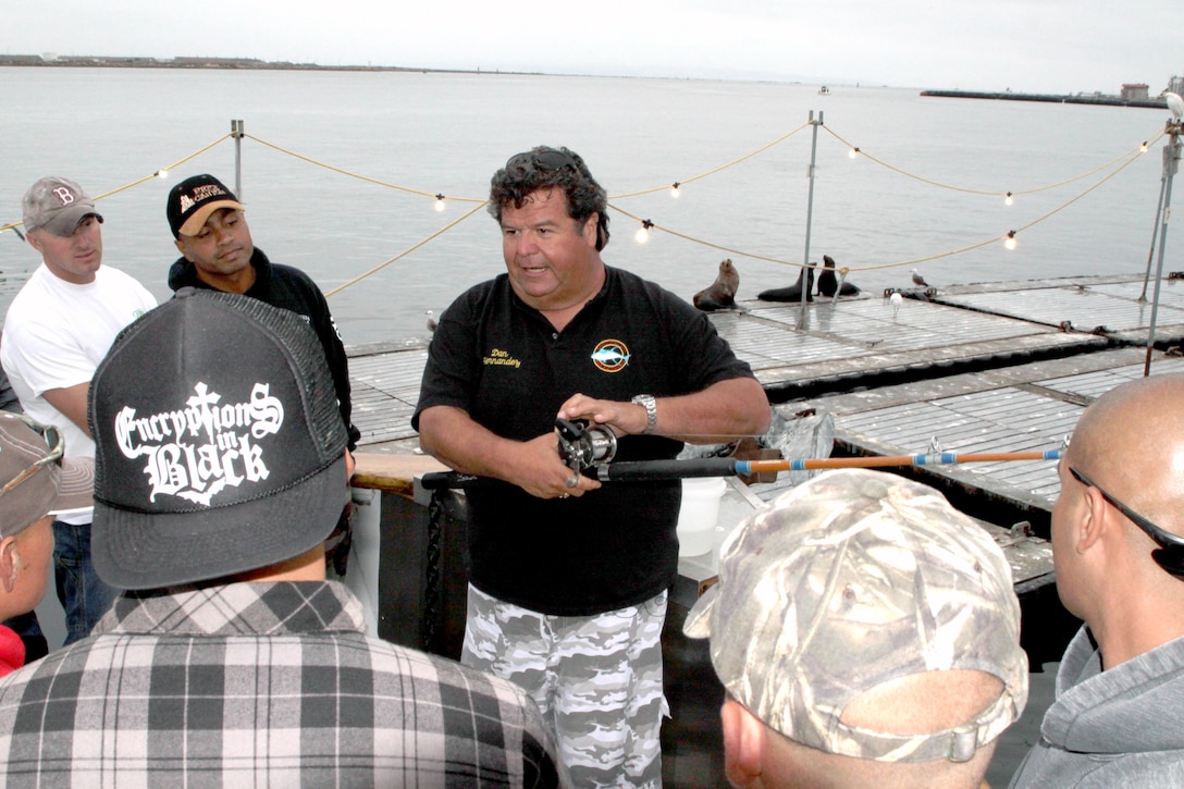 Dan Hernandez, executive producer of “Sportfishing with Dan Hernandez,” teaches a group of Marines from Marine Corps Recruit Depot San Diego how to use the fishing equipment that he provided June 29. Hernandez hosts an annual fishing trip to thank the Marines for their service.