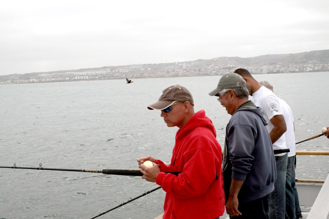 Larry Yoshida, charter master, gives depot Marines tips on equipment handling and other aspects of deep water fishing during the June 29 fishing expedition. Dan Hernandez, executive producer of cable’s “Sportfishing with Dan Hernandez,” has hosted the annual event for the last 14 years.