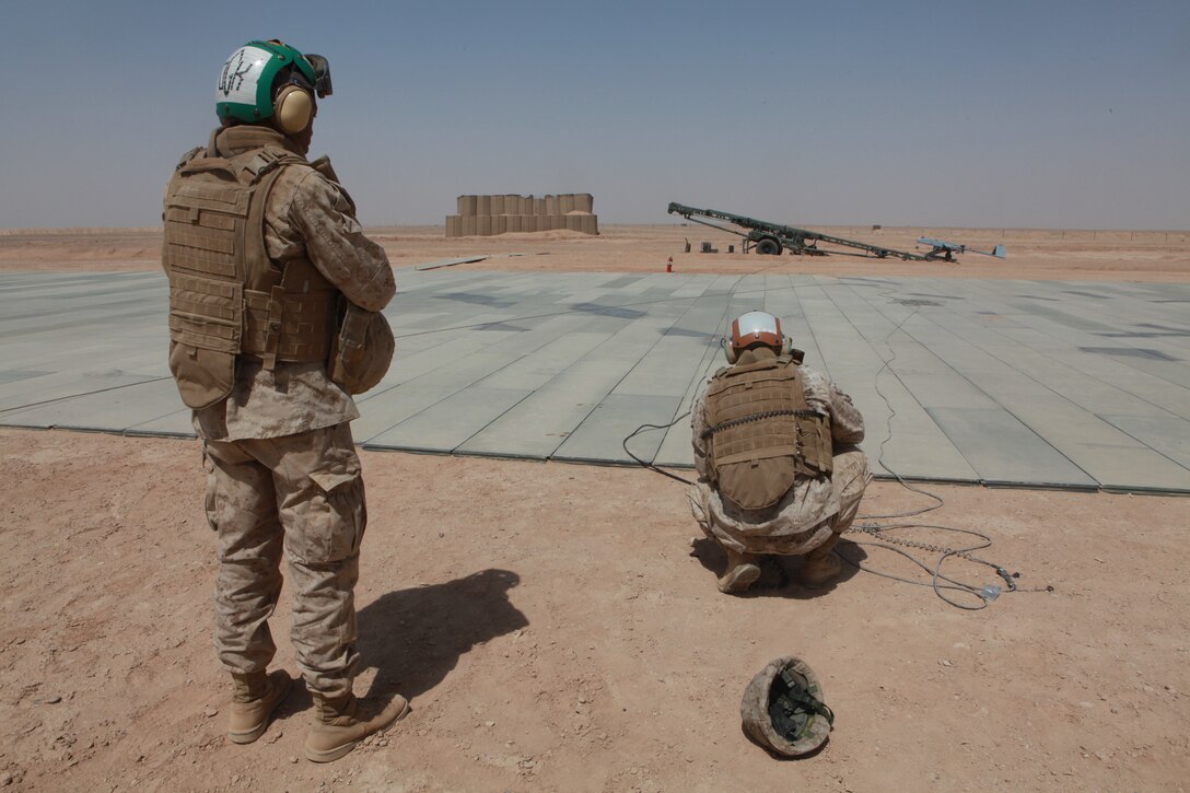 Cpl. Aaron H. Gibson, an unmanned aerial vehicle technician and Lance Cpl. Randy C. Akaeze, a supply clerk cross-training into the UAV technician job field, both with Marine Unmanned Aerial Vehicle Squadron 3, prepare an RQ-7B Shadow for the first operational launch of a VMU-3 UAV from Camp Leatherneck, Afghanistan, June 30.