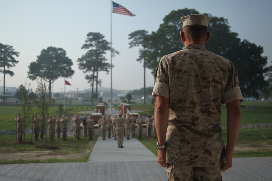 Maj. Gen. Jon M. Davis, right, commanding general of the 2nd Marine Aircraft Wing, stands at attention during Marine Corps Air Station Cherry Point’s morning colors ceremony outside of the headquarters building June 30. The 2nd MAW band performed at the ceremony to help celebrate the 2nd MAW’s proud history and play the National Anthem during the raising of the colors. 2nd MAW, activated and commissioned July 10, 1941, turned 70 on Sunday. Twice a month the 2nd MAW band is invited to play at morning colors to help celebrate 2nd MAW’s proud history.