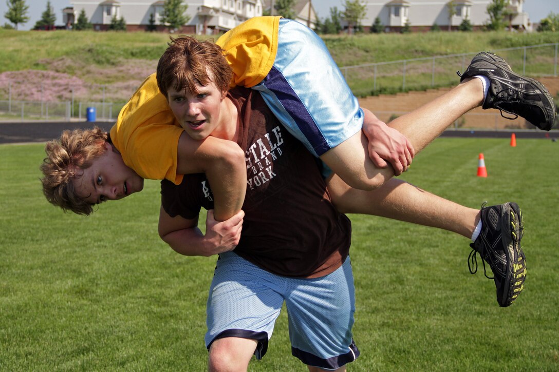 A member of the Prior Lake Varsity Strength and Conditioning Team runs toward the next obstacle during the maneuver-under-fire portion of a modified combat fitness test at Dan Patch Stadium June 30. Recruiters from the Burnsville, Minn., office proctored the CFT and recognized the top three athletes from each stage with Marine memorabilia. For additional imagery from the event, visit www.facebook.com/rstwincities.