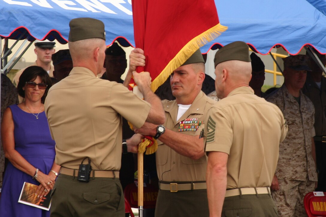 Maj. Gen. Mark A. Brilakis, left, outgoing commanding general of 3rd Marine Division, III Marine Expeditionary Force, passes the division colors to Brig. Gen. Frederick M. Padilla, the division's incoming commanding general, during a change of command ceremony June 30 in front of the division's headquarters on Camp Courtney. Padilla, who has been selected for promotion to major general, told those watching the ceremony, “I am looking forward to the challenge. I am looking forward to building on the legacies, the history that is the 3rd Marine Division.”