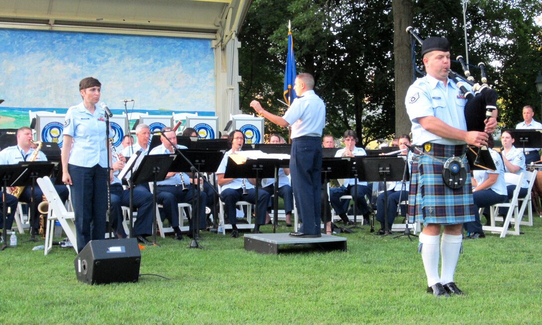 Guilford, CT:  SSgt James Noury (right)  plays "Going Home" on the bagpipes during an evening concert on the "Green" in Guilford, CT.  SSgt Ruth Petkaitis (left) looks on prior to joining in.  The Air National Guard Band of the Northeast is currently touring the New England/New York region on an Independence Day Tour named "American's We."