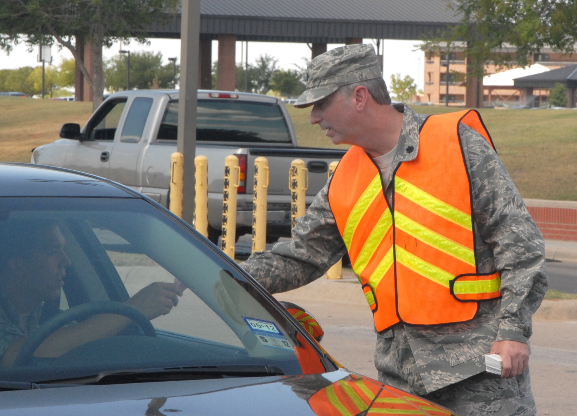GOODFELLOW AIR FORCE BASE, Texas -- Lt. Col. John Cupp III, 17th Training Group Deputy Commander, joined other base leaders June 30 at the North and South gates to hand out Safety cards to Team Goodfellow members departing for the long holiday weekend.  (U.S. Air Force photo/Connie Hempel)
