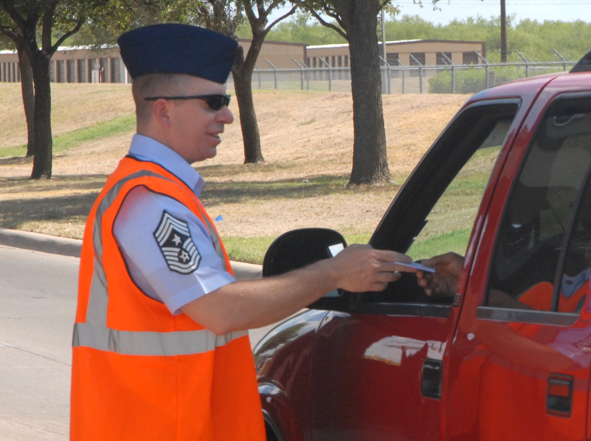 GOODFELLOW AIR FORCE BASE, Texas -- Chief Master Sgt. Brendan Criswell, 17th Training Wing Command Chief, joined other base leaders June 30 at the North and South gates to hand out Safety cards to Team Goodfellow members departing for the long holiday weekend.  (U.S. Air Force photo/Connie Hempel)